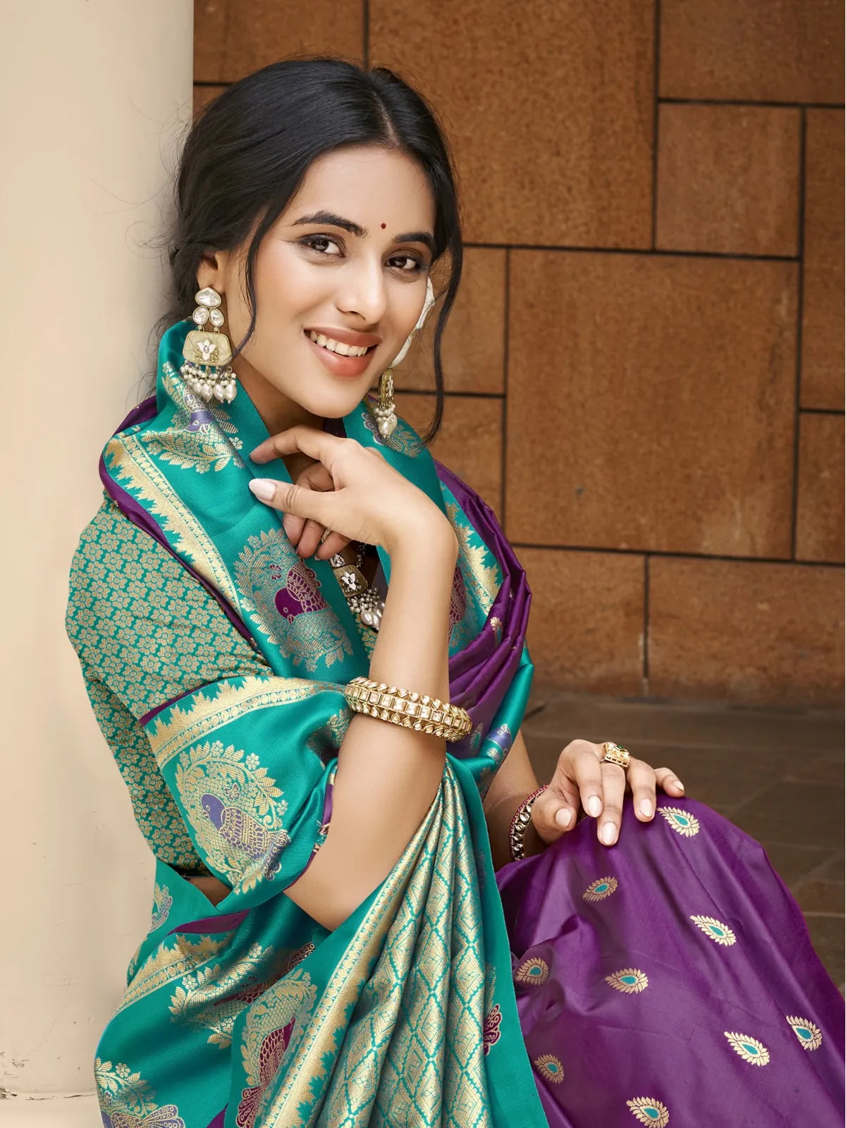 Tarani upper body view of purple silk saree with zari border and traditional motifs