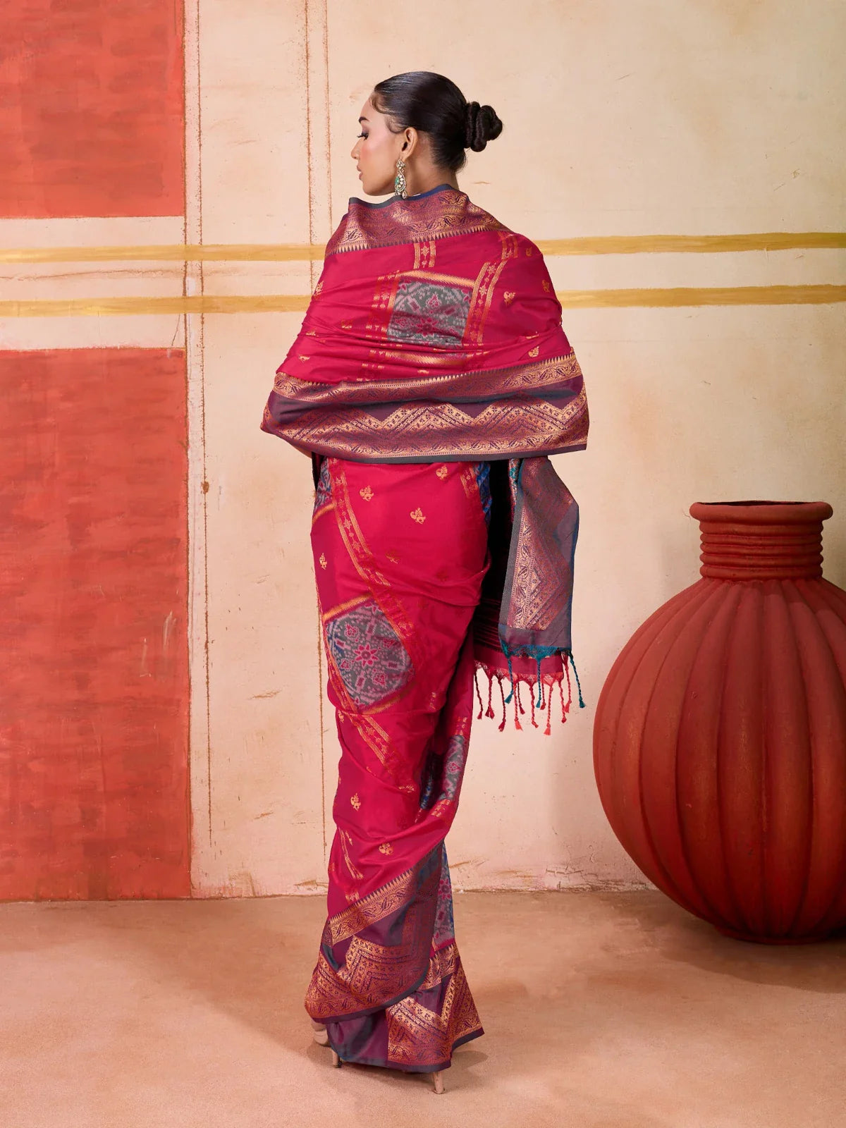 Back view of red silk Tarani saree showcasing overall drape and traditional appeal