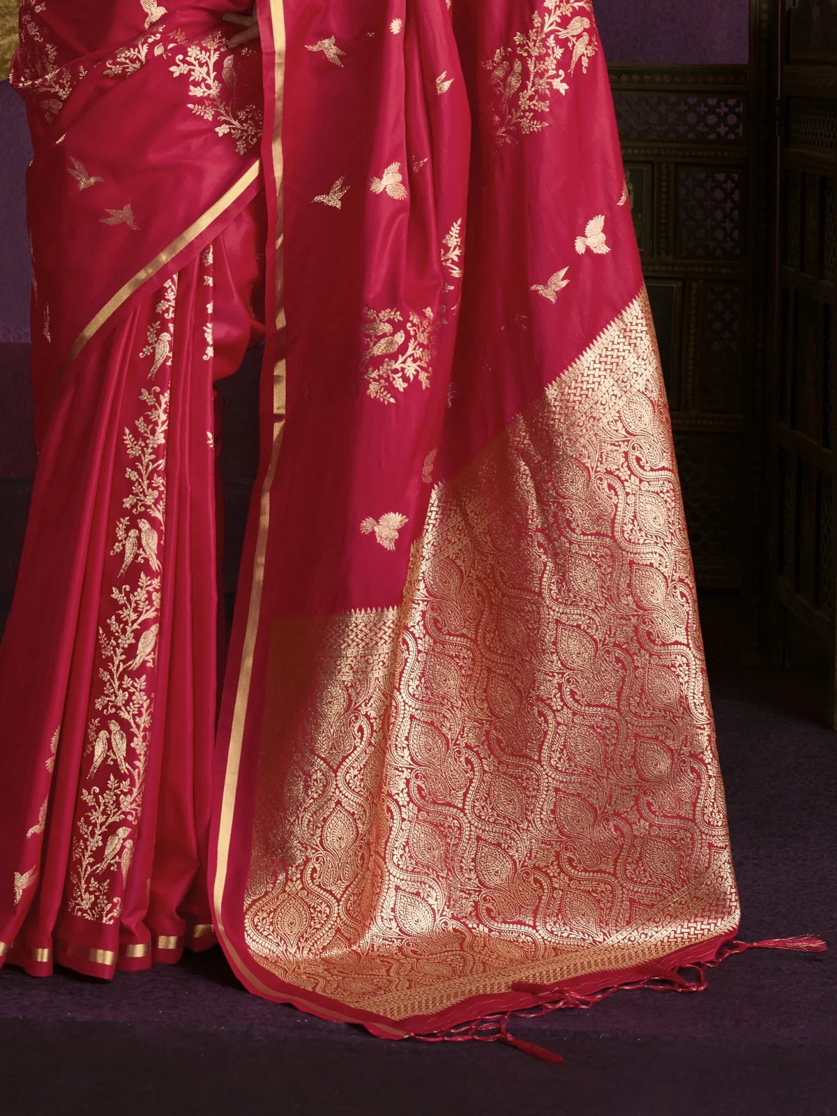 Tarani red silk saree pallu with intricate golden zari weaving and bird detailing