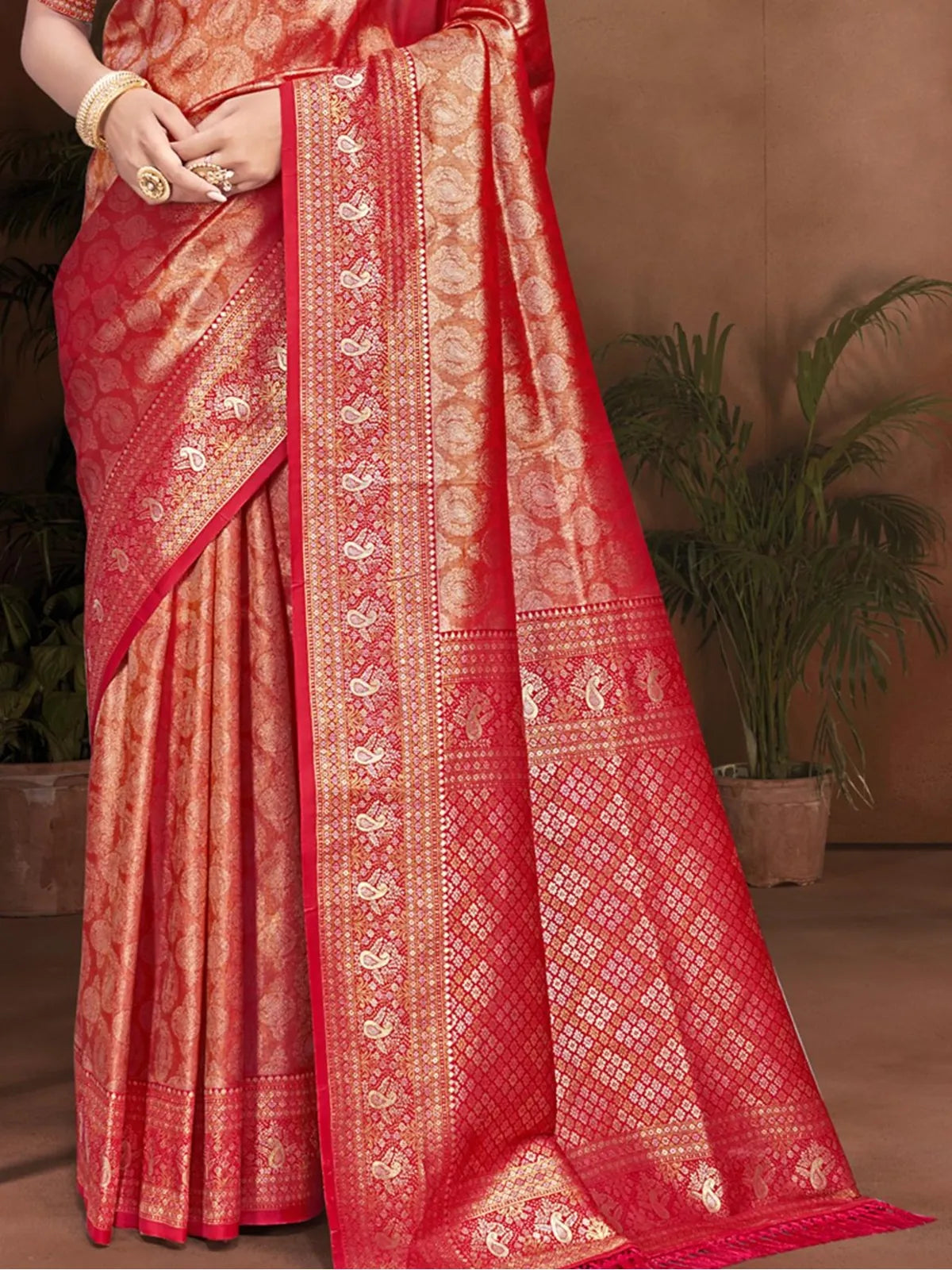 Tarani red kanjivaram silk saree pallu view showcasing intricate golden border and motifs