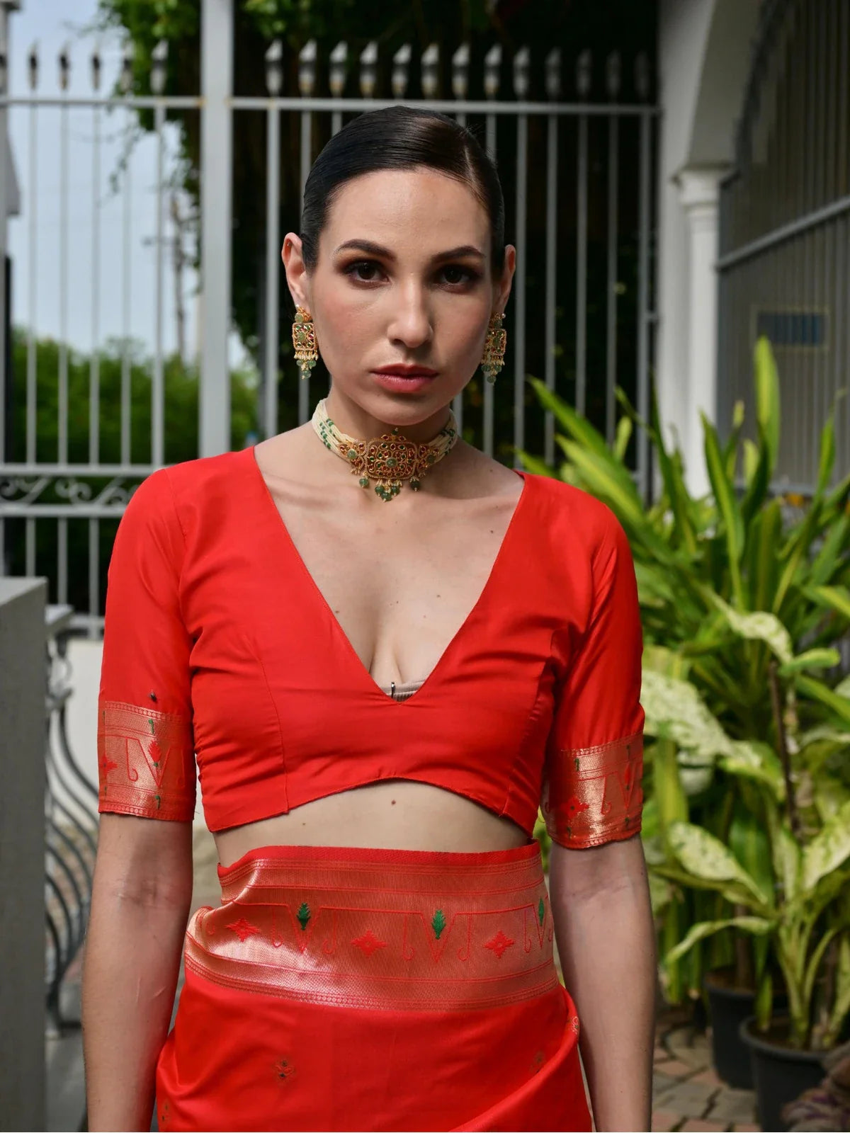 Tarani red saree blouse with zari detailing and deep neckline - upper body model view