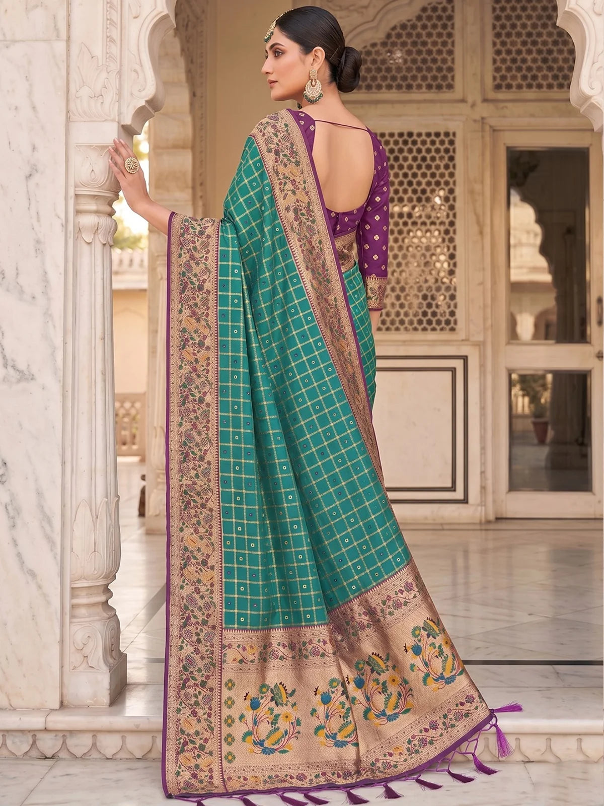 Tarani Yutika teal Banarasi silk saree back view with decorative pallu and tassels