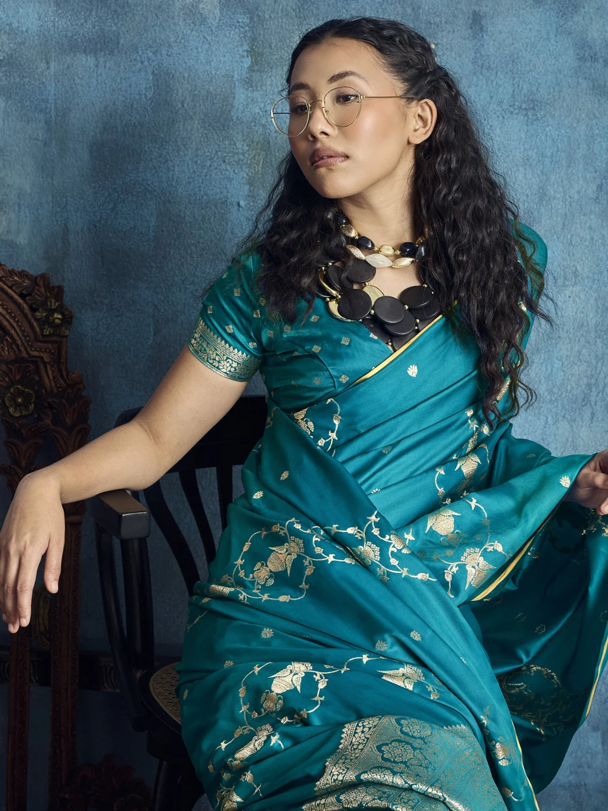 Tarani Dayita teal satin saree closeup view highlighting blouse detailing and woven zari motifs