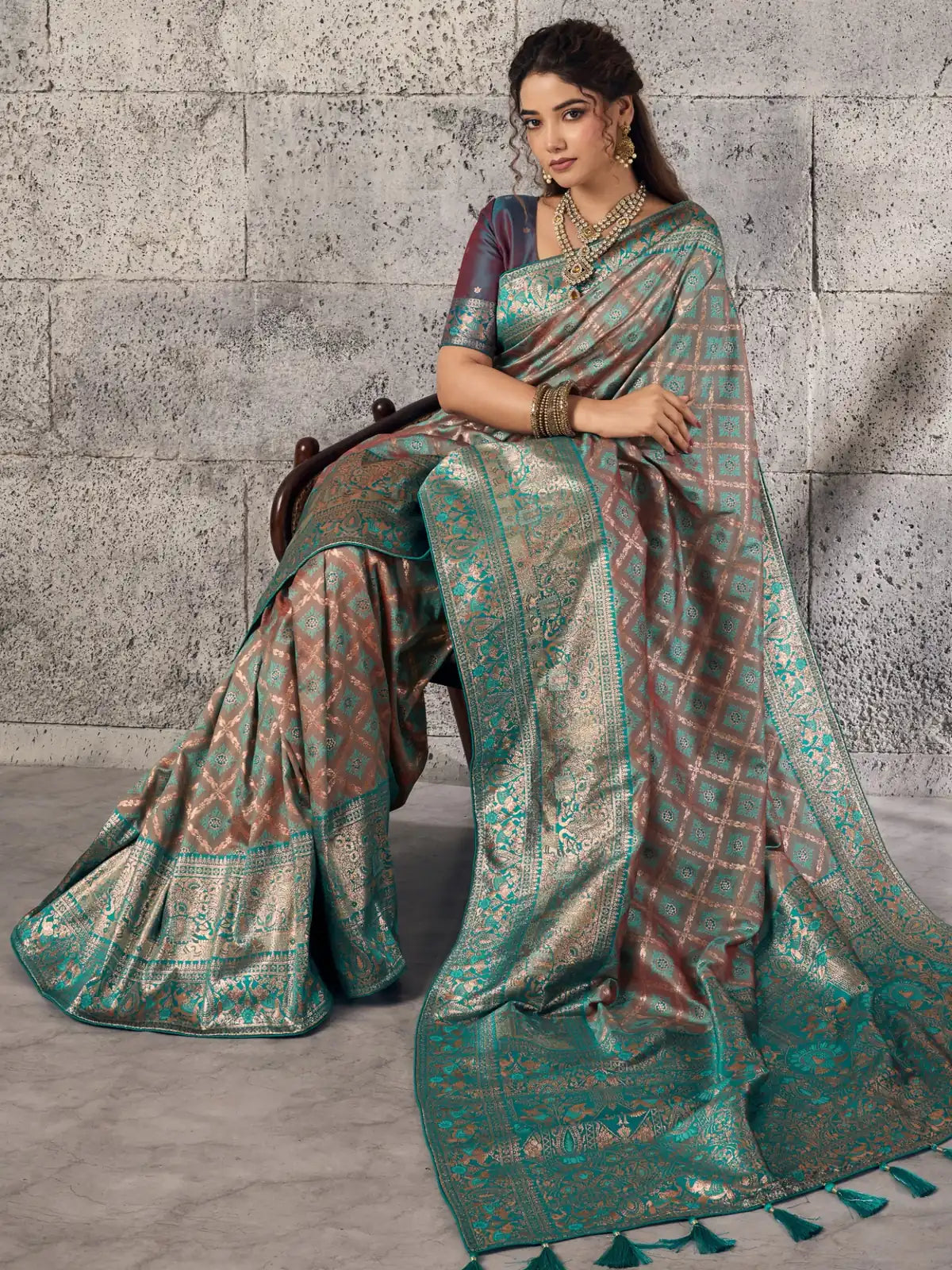 Tarani teal Banarasi silk saree seated full view with rich pallu
