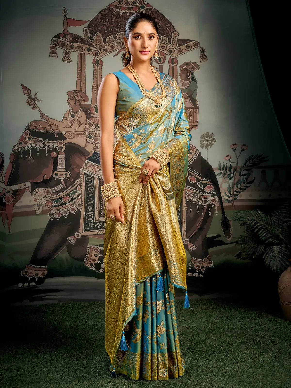 Tarani premium teal silk saree full view with rich golden zari for festive and party wear