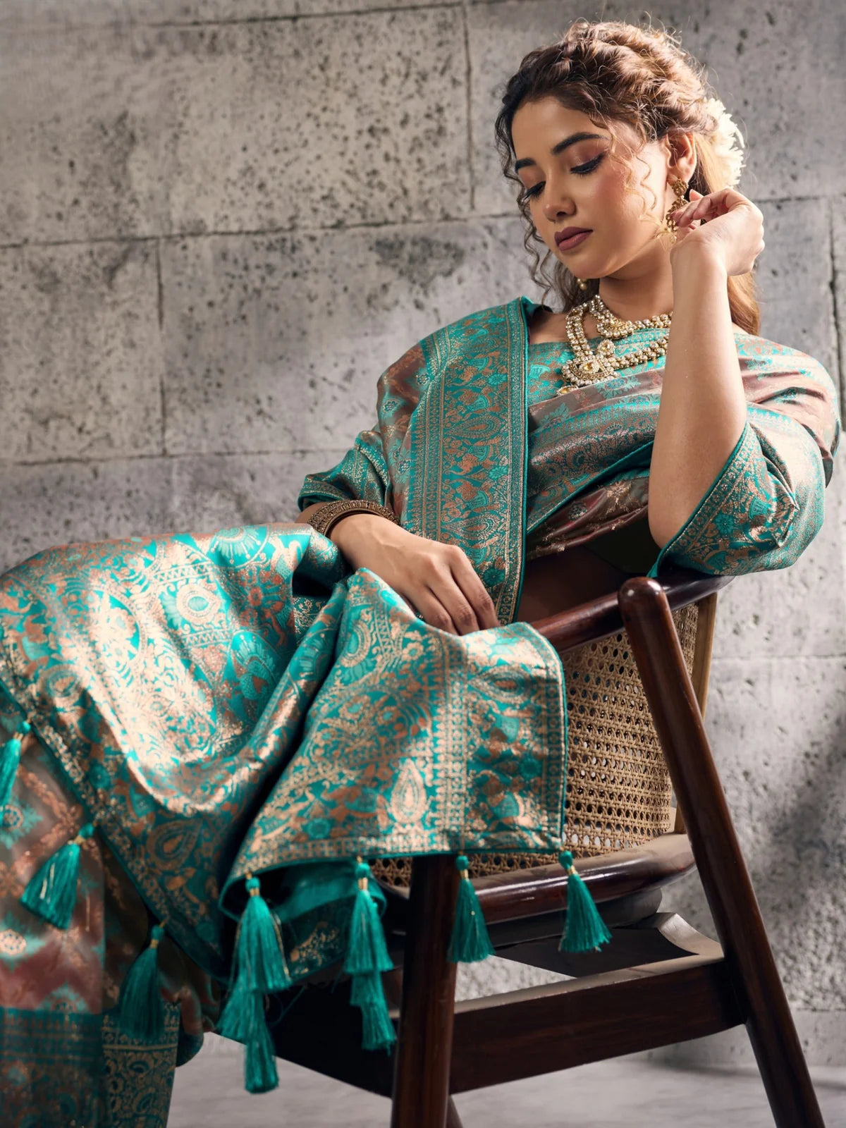 Tarani teal Banarasi silk saree pallu view with tassels and woven border