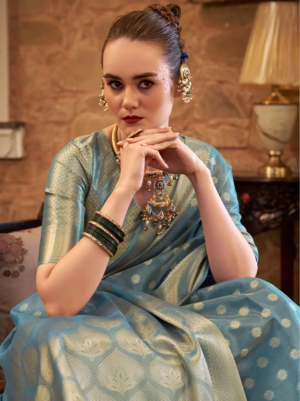 Tarani closeup of turquoise tissue silk saree showing woven zari texture and motifs