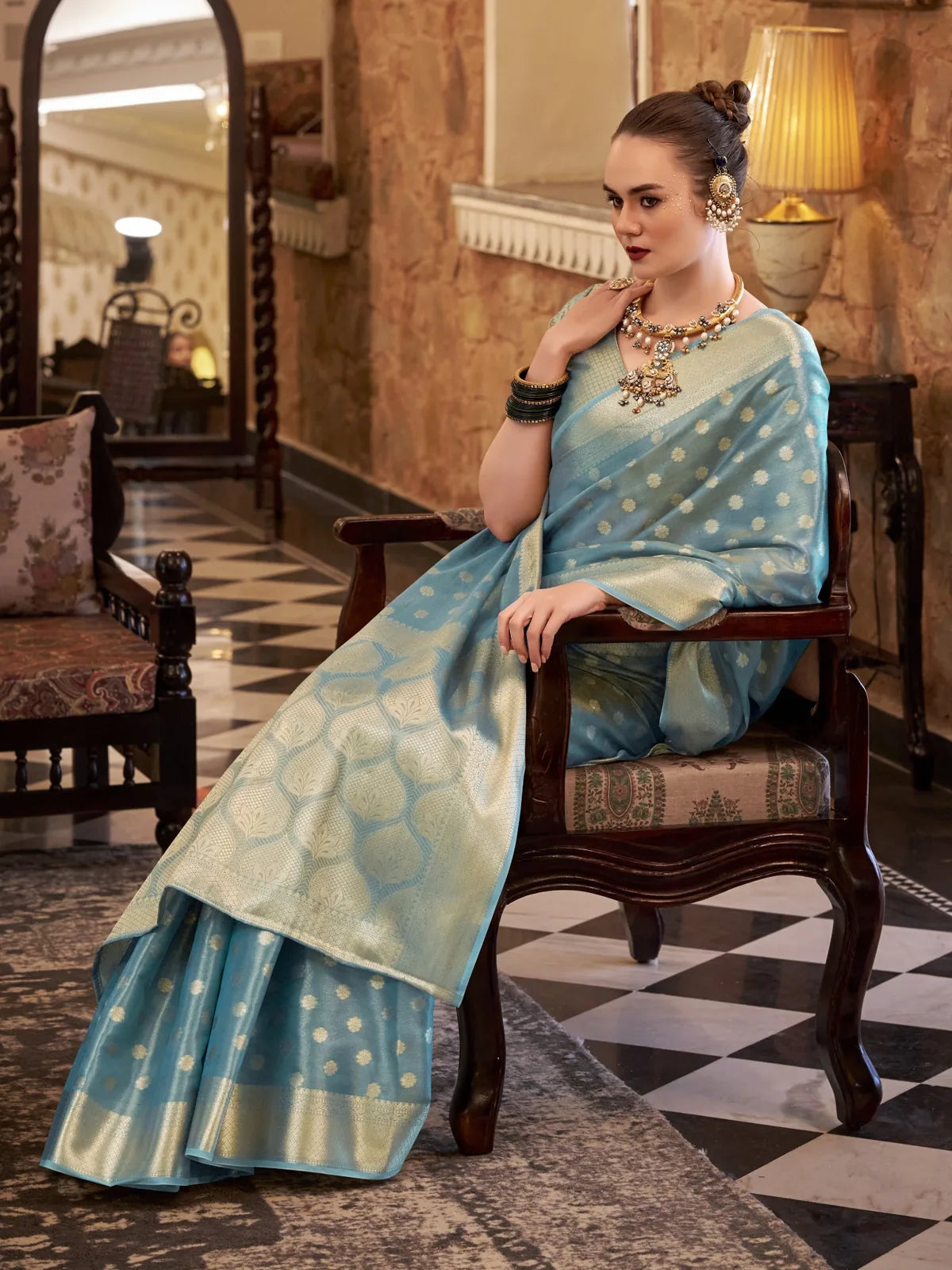 Tarani turquoise tissue silk saree front view highlighting pallu and woven border