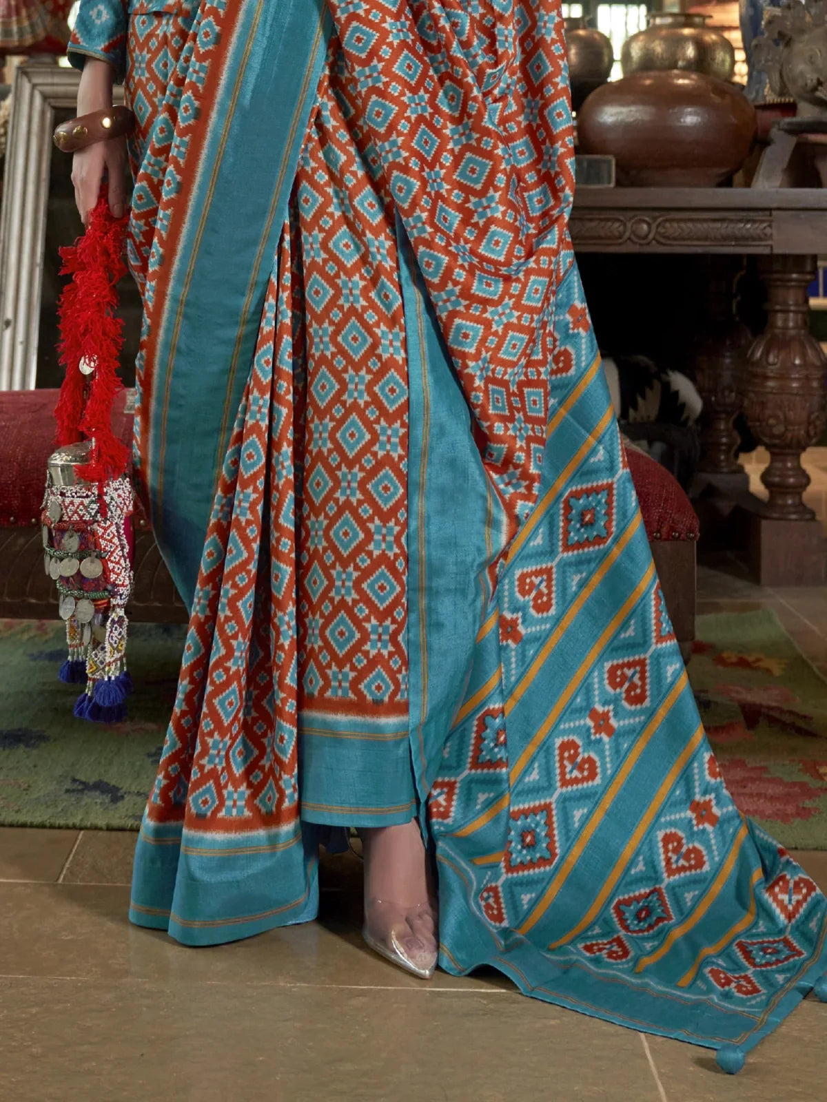 Tarani turquoise silk saree pallu closeup with traditional ikkat pattern and detailed weave