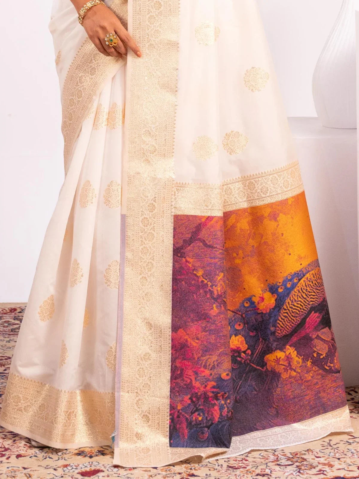 Tarani soft white banarasi silk saree closeup showing zari motifs and border