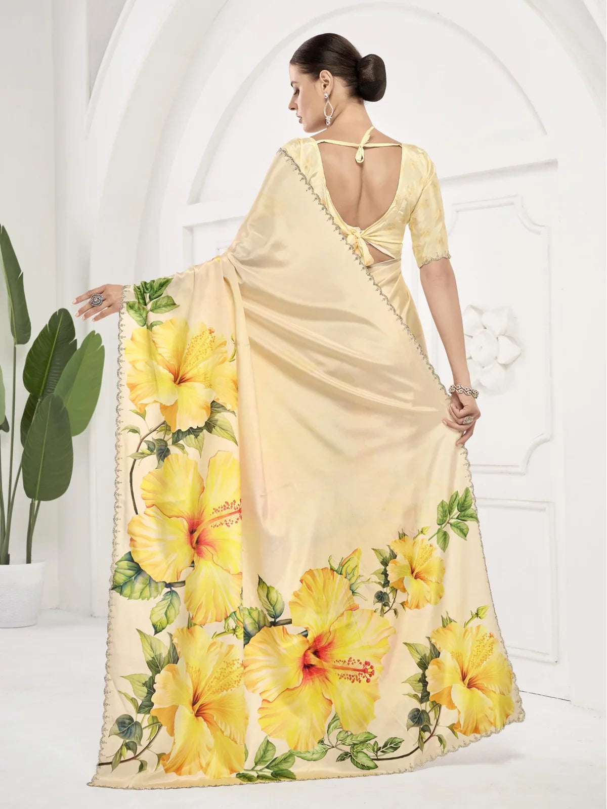 Tarani yellow saree back view with floral motifs and deep back blouse design