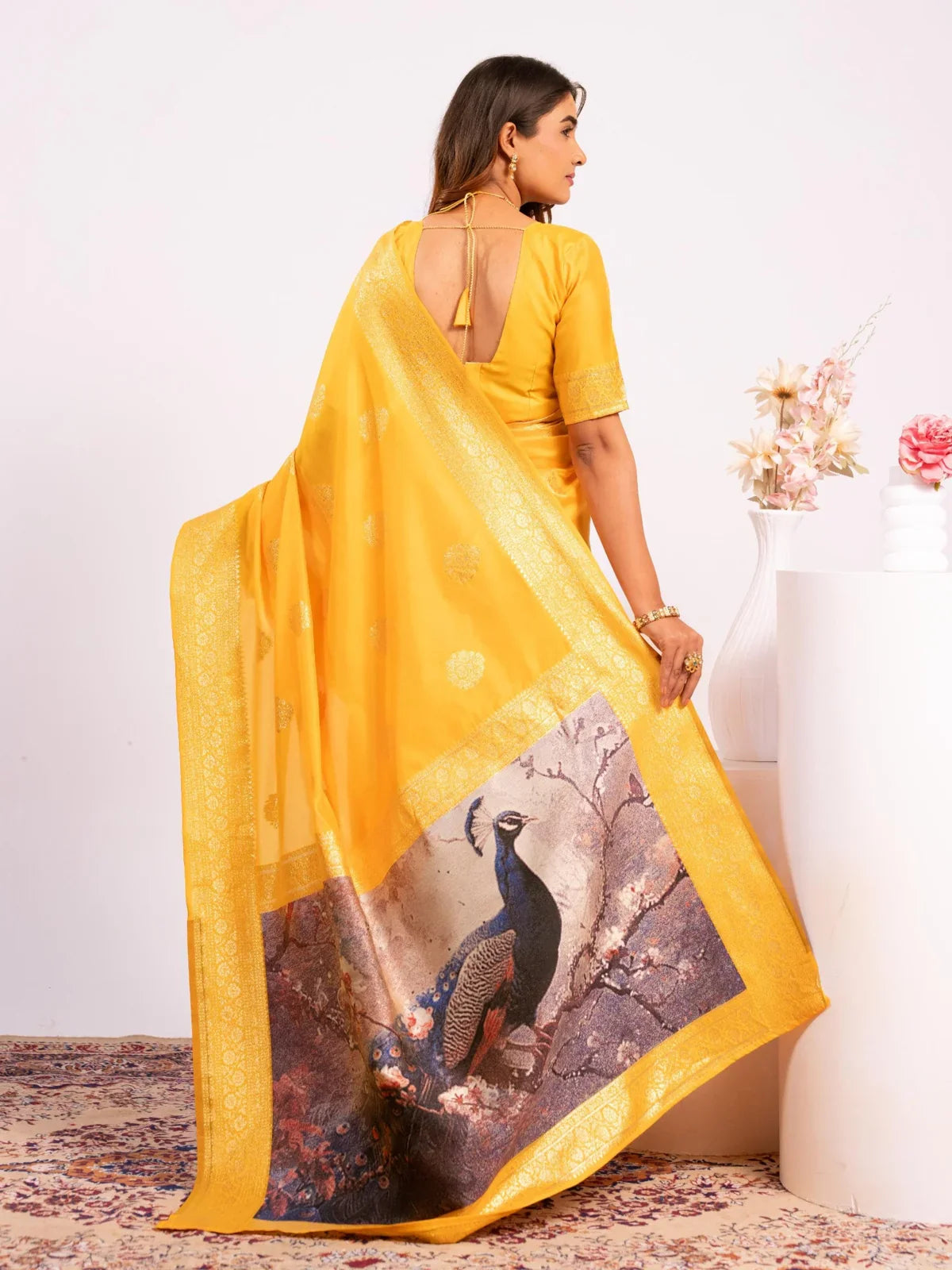 Tarani yellow silk saree back view with traditional motifs and stylish blouse pairing