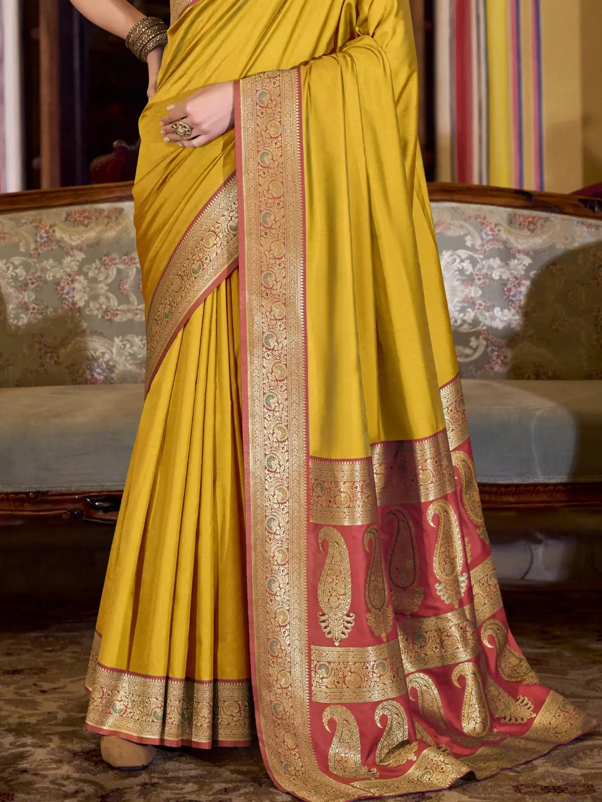 Tarani closeup yellow silk saree fabric with intricate zari border design