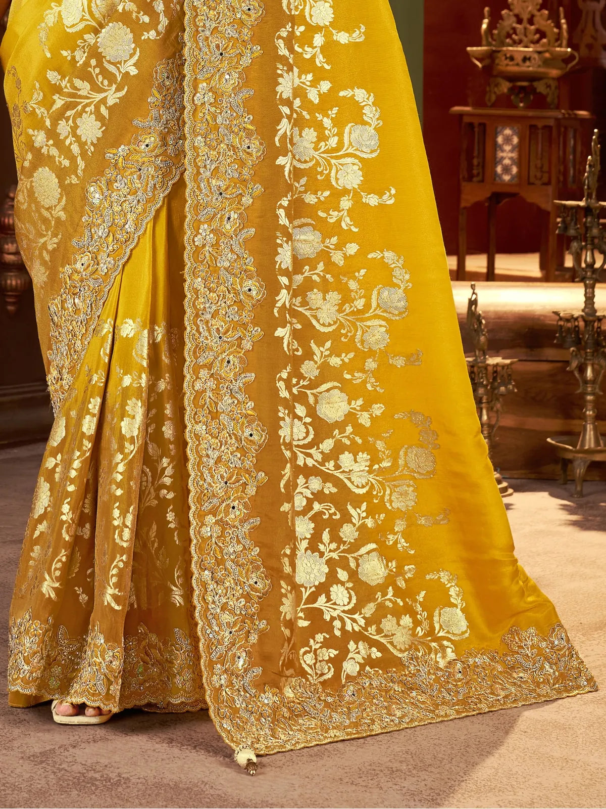 Tarani pallu close view of yellow silk saree with zari floral motifs and latkan highlights