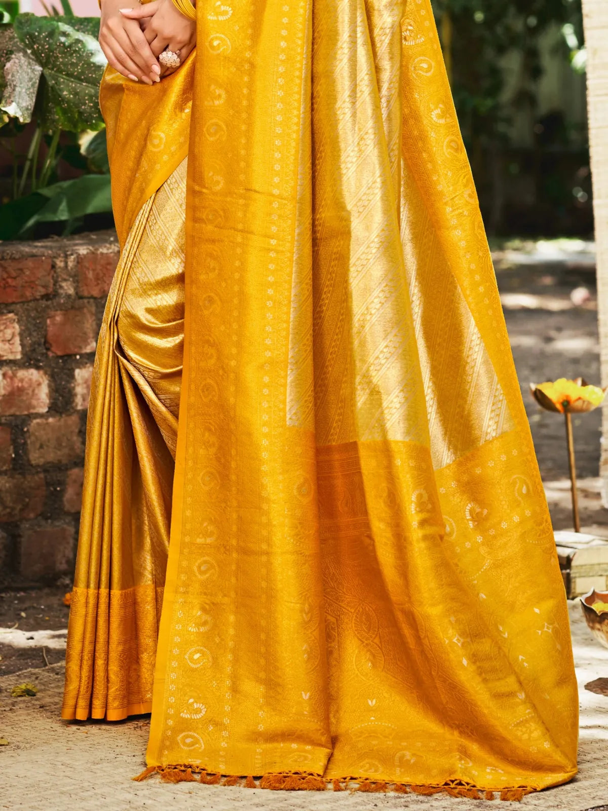 Tarani yellow Kanjivaram silk saree pallu view showcasing intricate border and woven details