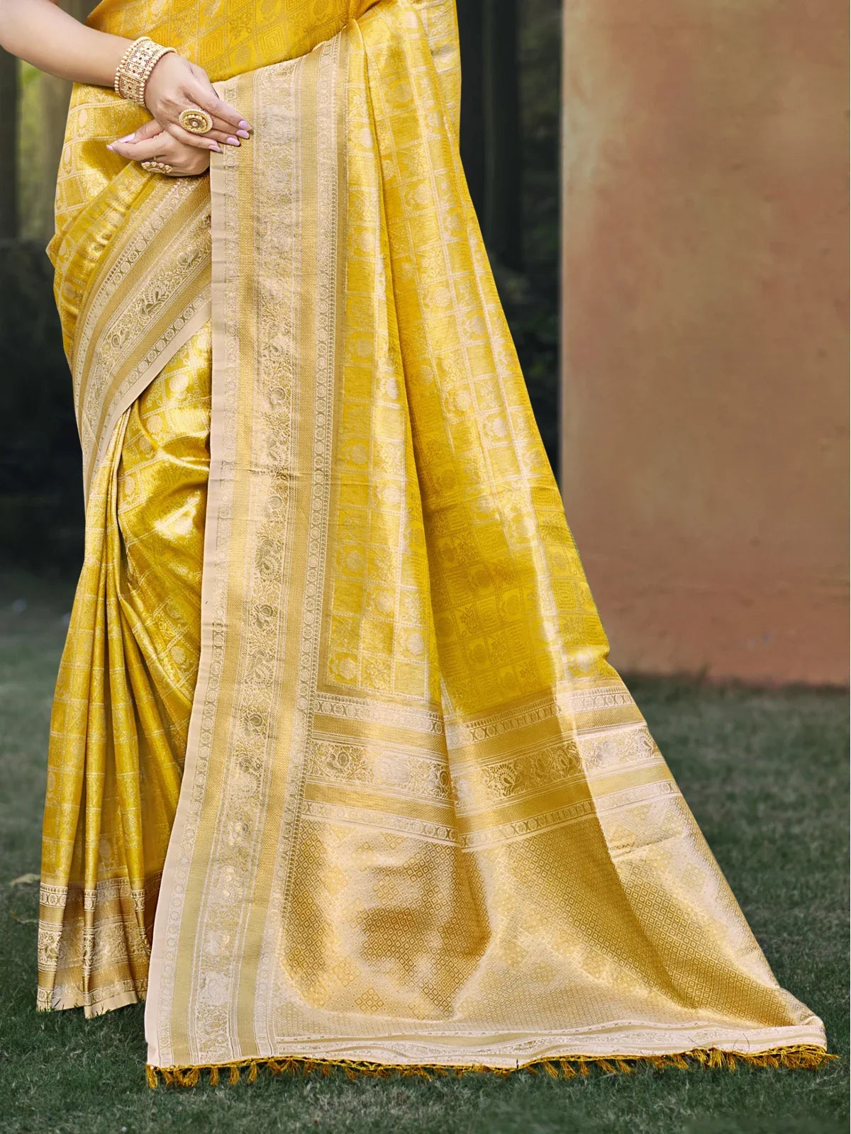 Tarani yellow kanjivaram silk saree pallu view highlighting intricate zari weave