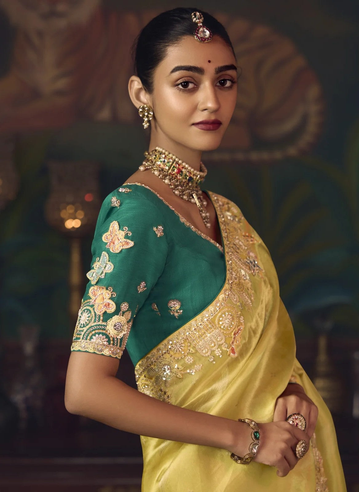 Tarani yellow silk saree with green embroidered blouse close-up upper body view