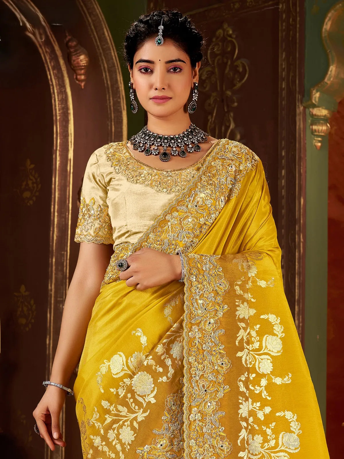 Tarani close-up of model in yellow silk saree with embroidered blouse and ethnic jewellery
