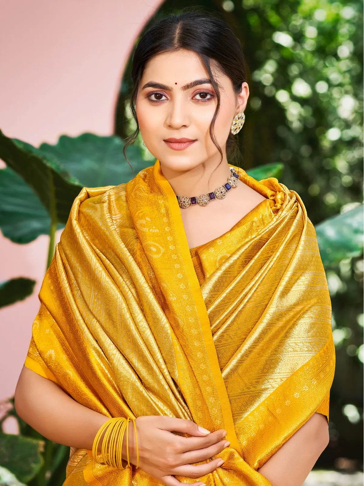 Tarani yellow Kanjivaram silk saree upper body view with matching blouse and jewellery