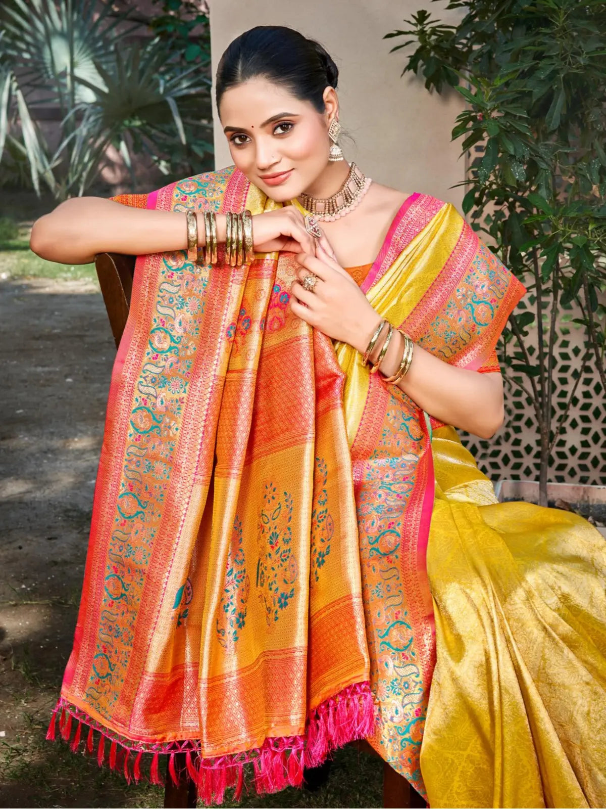 Tarani yellow kanjivaram silk saree showing elegant upper body drape and coral border