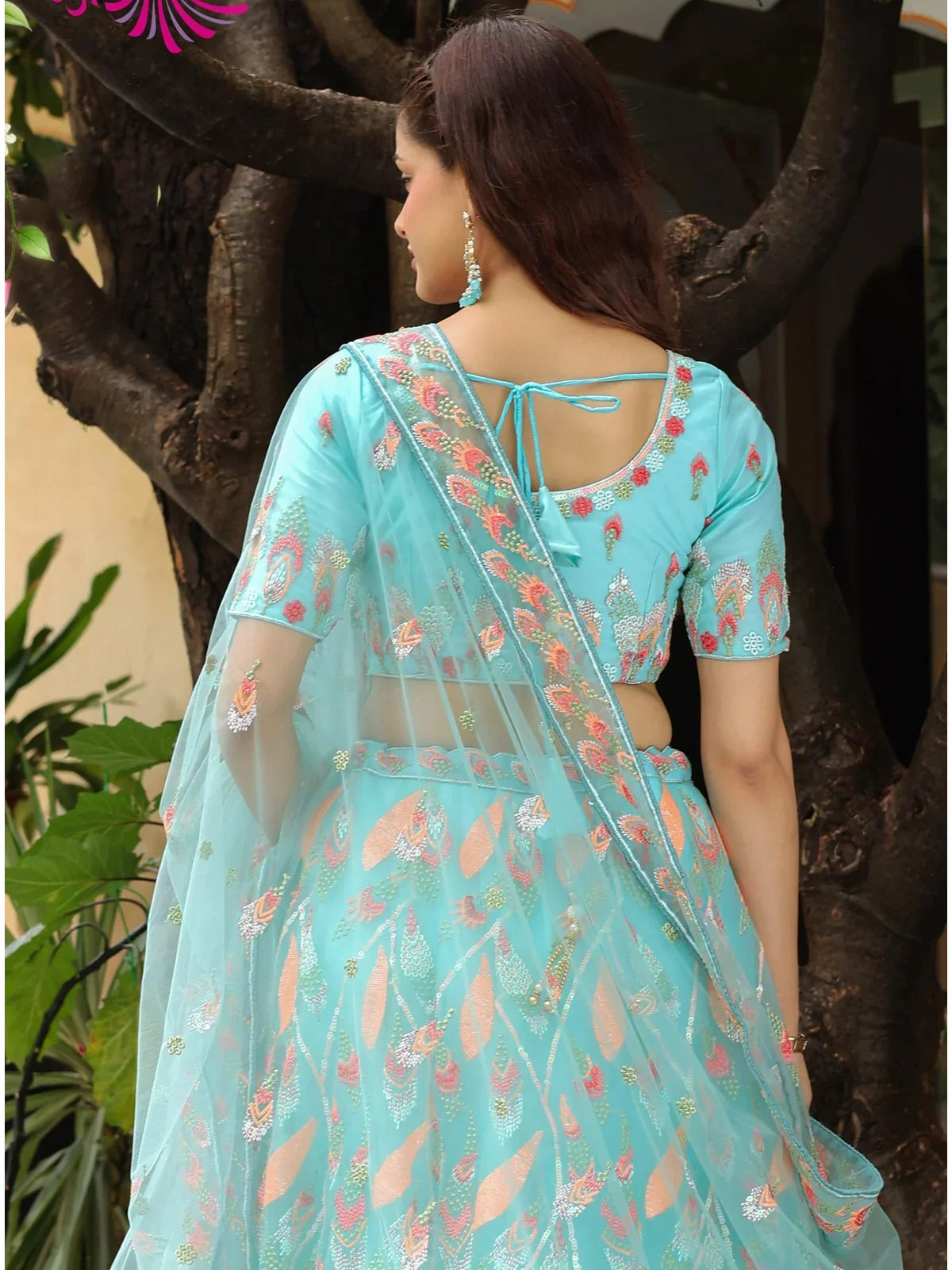 Tarani turquoise soft net lehenga back view with blouse tie design and dupatta fall