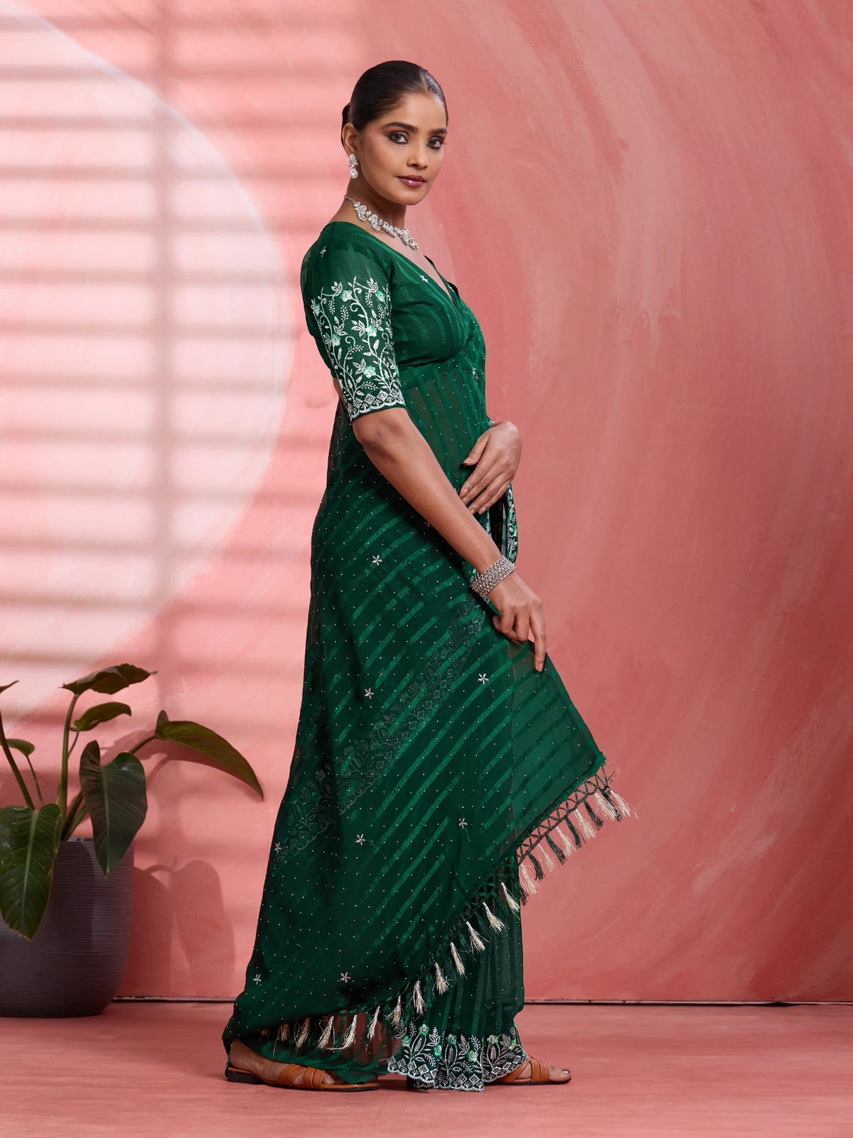 Tarani green solo chiffon saree side view with elegant drape and border work