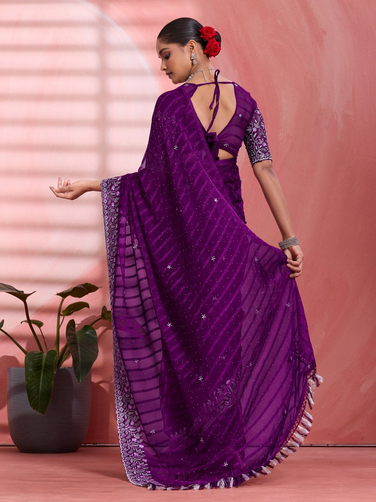Tarani purple solo chiffon saree back view with flowing pallu and tassel border