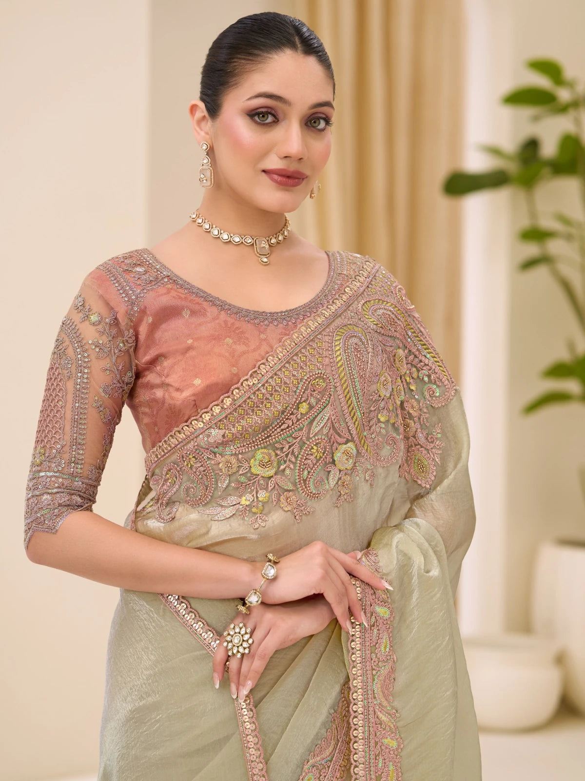 Tarani Kumudini pallu view of sage green Sunsilk tissue saree with embroidery and zari border detailing