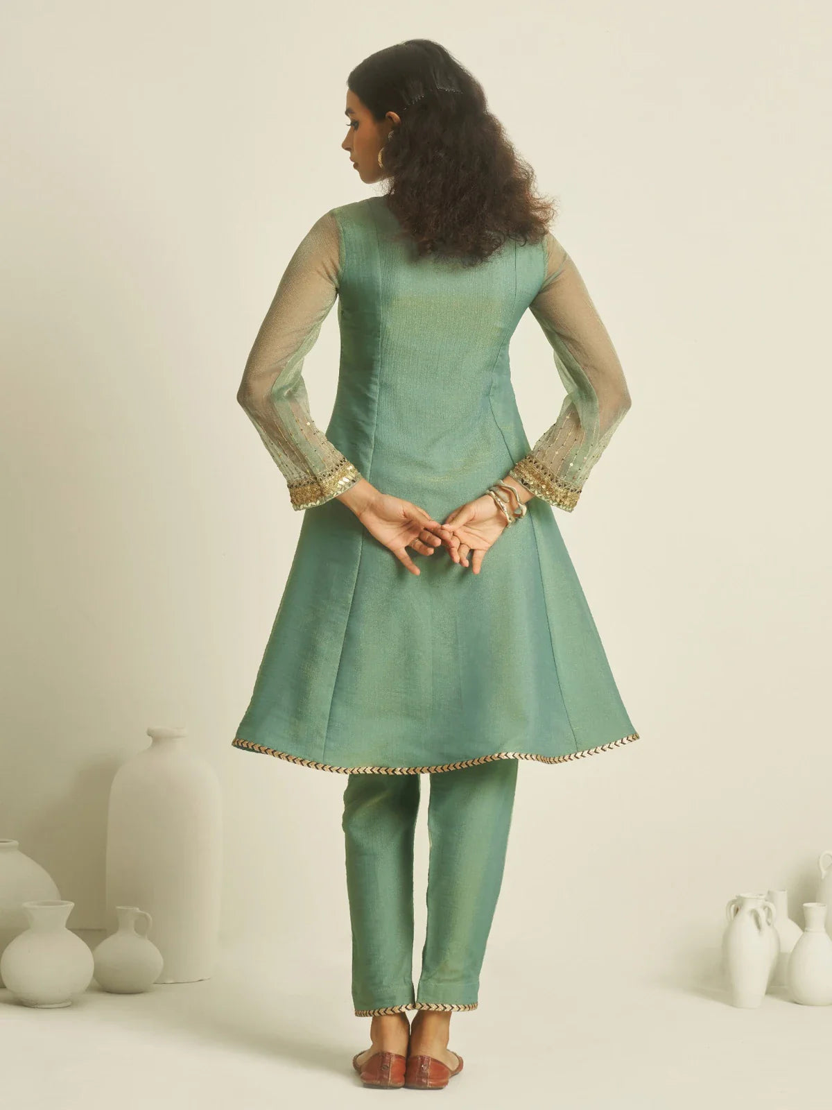 Tarani tissue dress back view showcasing the full silhouette with embroidered sleeve ends