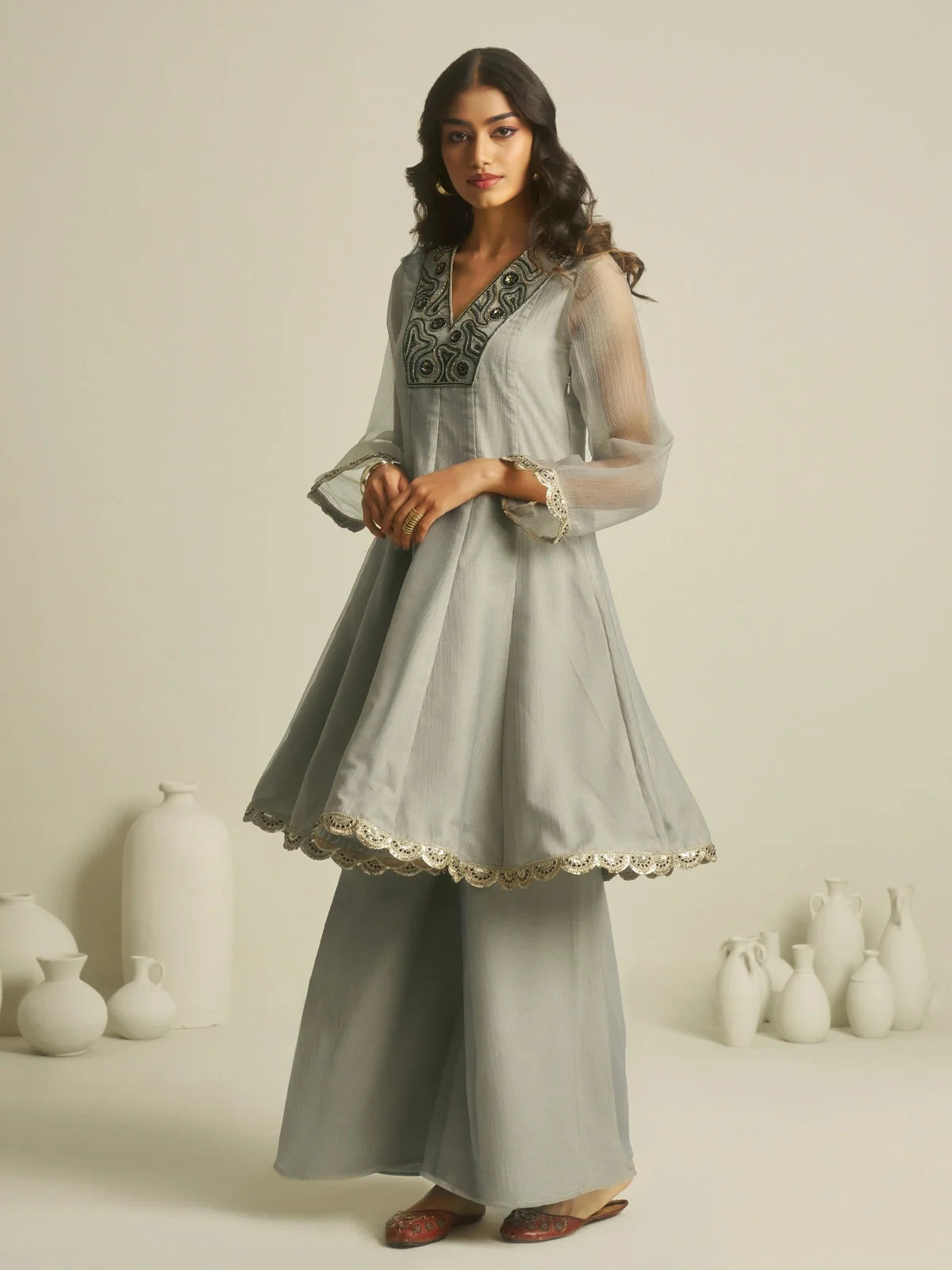 Tarani full front view of premium grey tissue dress with flared silhouette and palazzo