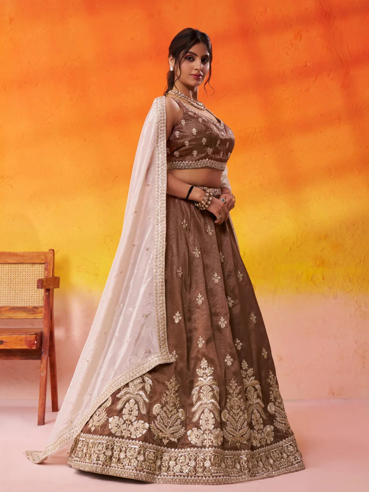 Tarani side view of brown lehenga in tissue fabric with intricate work
