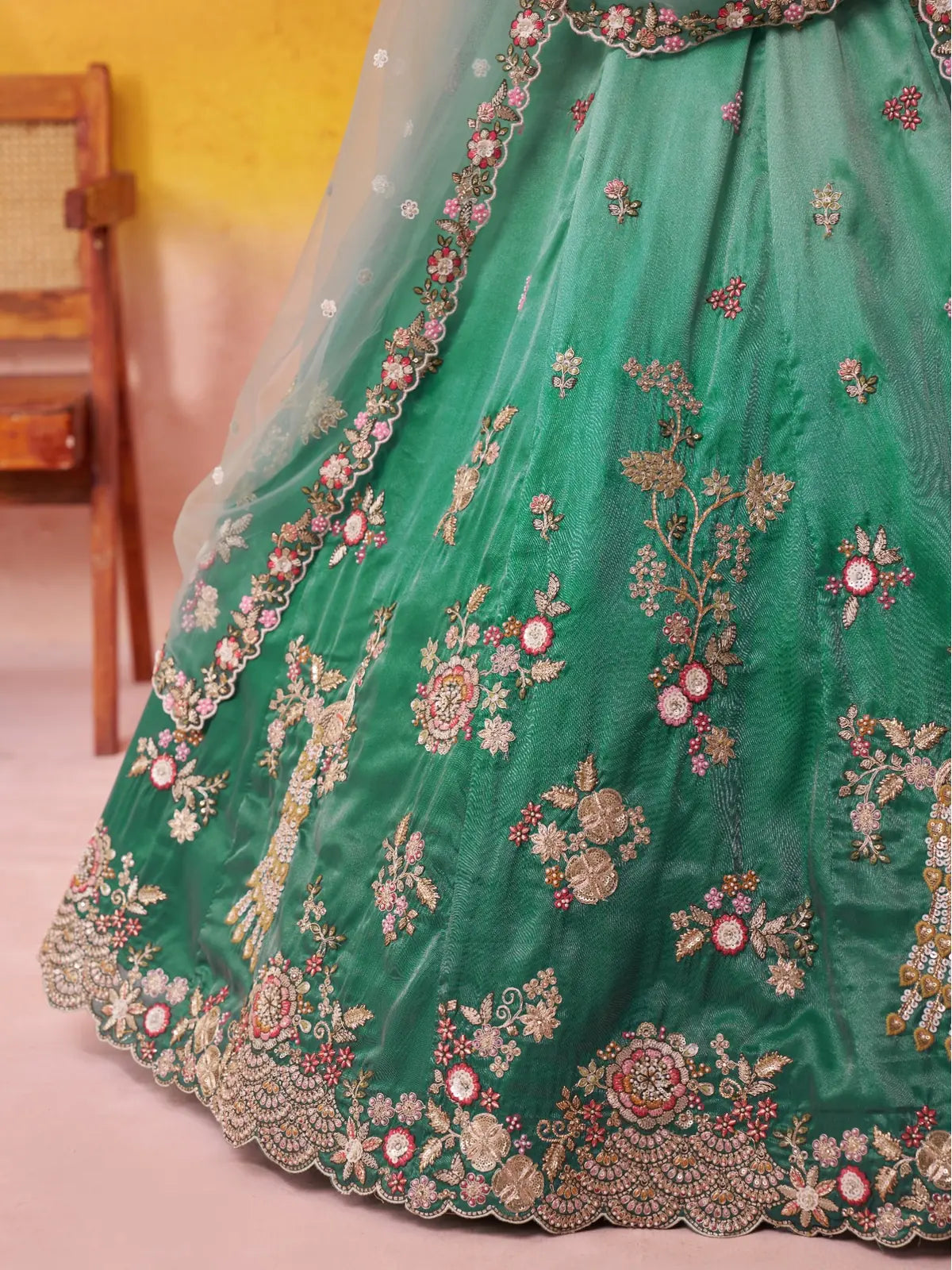 Tarani closeup of lehenga fabric embroidery and scallop border in tissue material