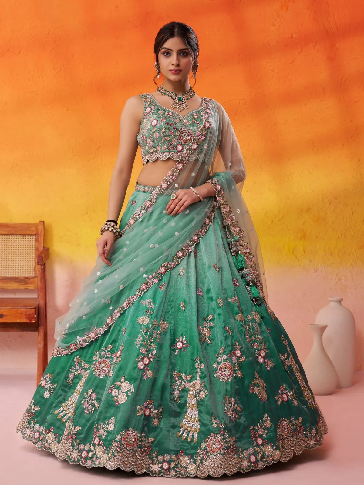 Tarani premium green tissue lehenga full view with floral embroidery and handcrafted tassels