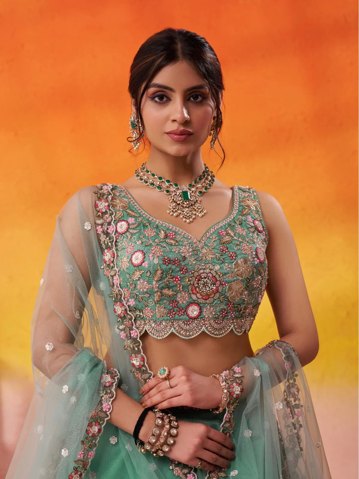 Tarani close-up of embroidered blouse and neckline in green tissue lehenga set