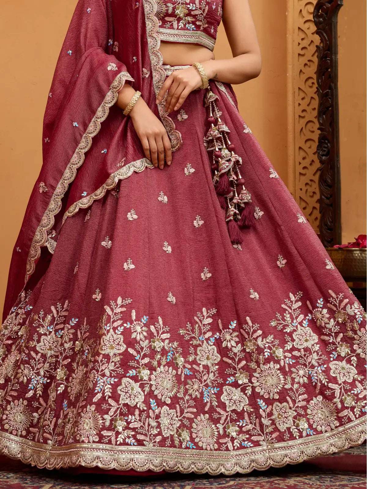 Tarani closeup maroon tissue lehenga showing floral sequins embroidery and border design
