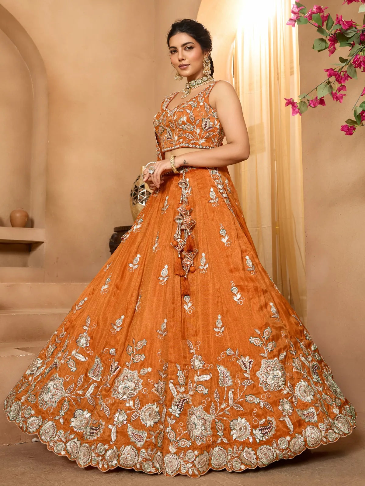 Tarani side pose orange tissue lehenga showcasing embroidery and dupatta