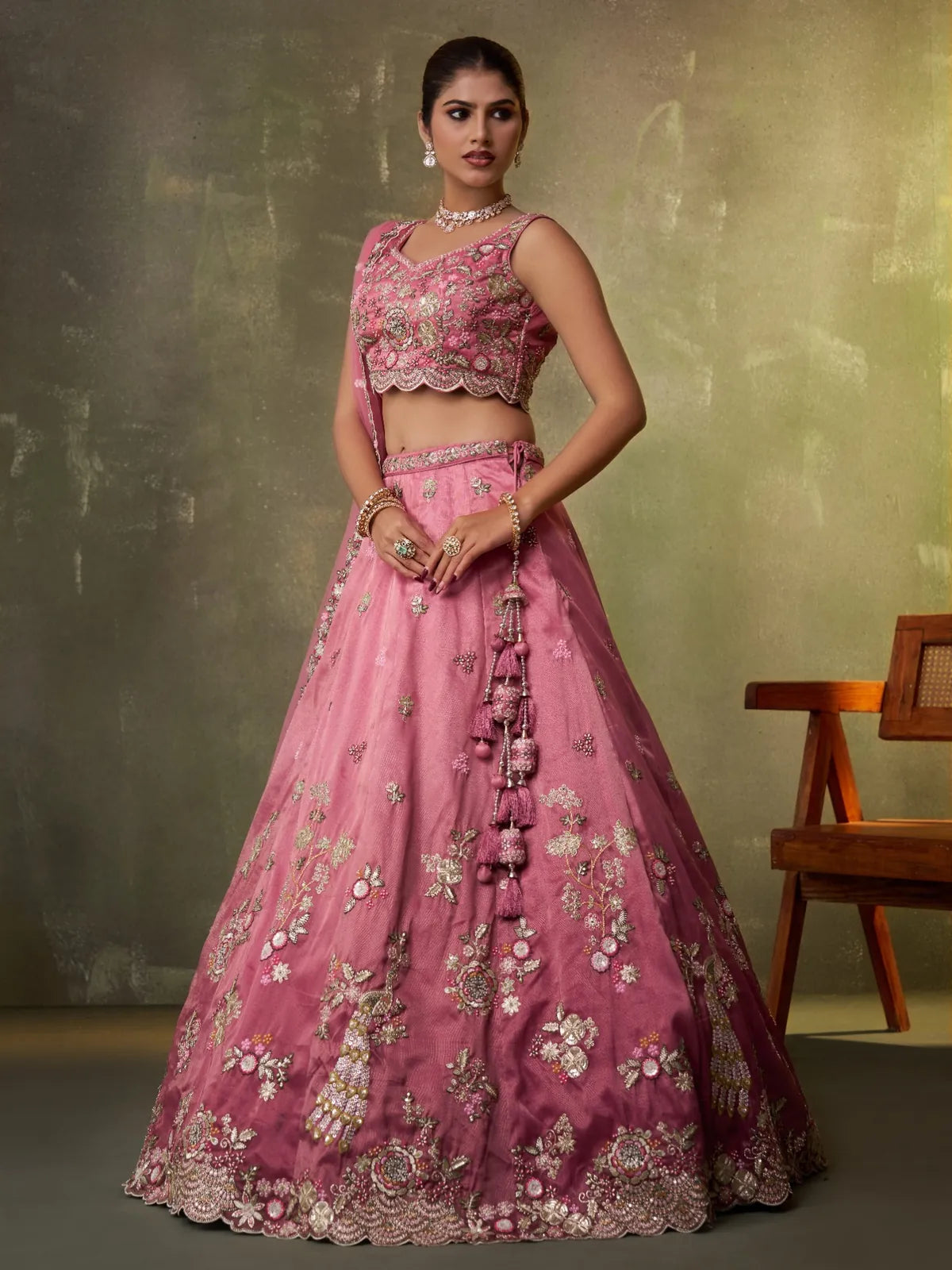 Tarani side view of pink tissue lehenga with latkans and detailed embroidery