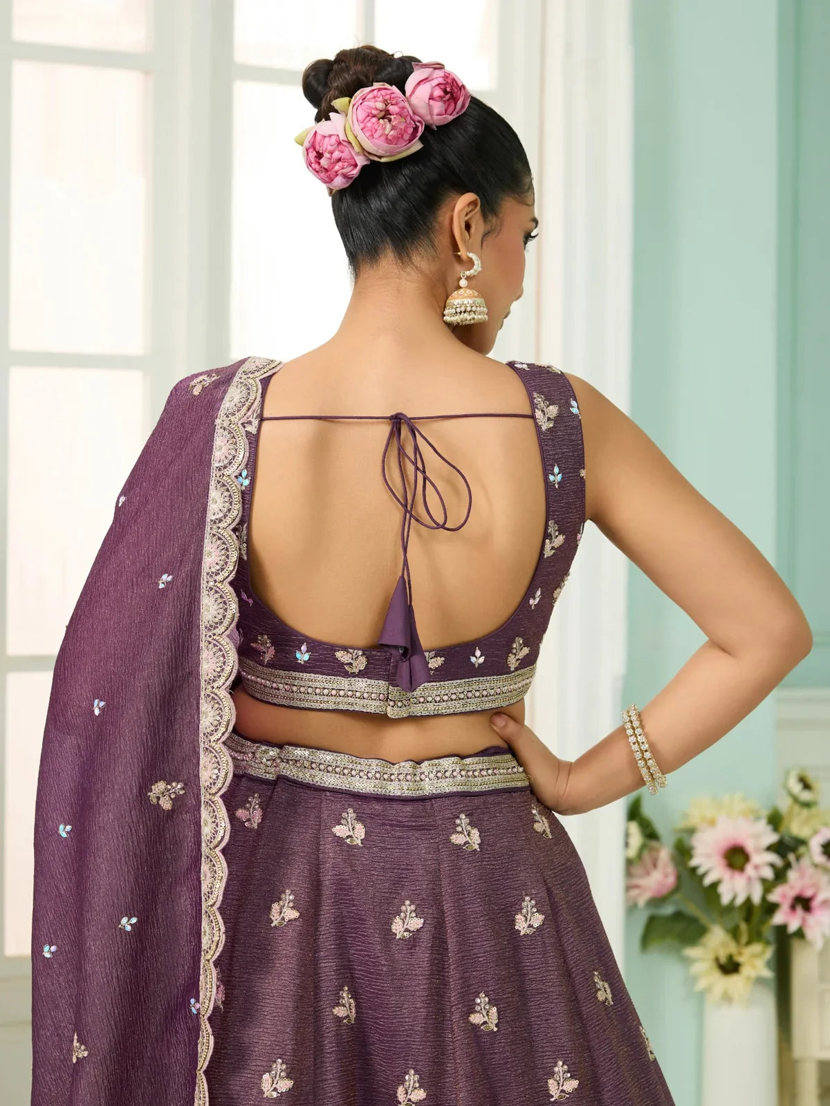 Tarani purple tissue lehenga back blouse design with tie-up and floral embellishments