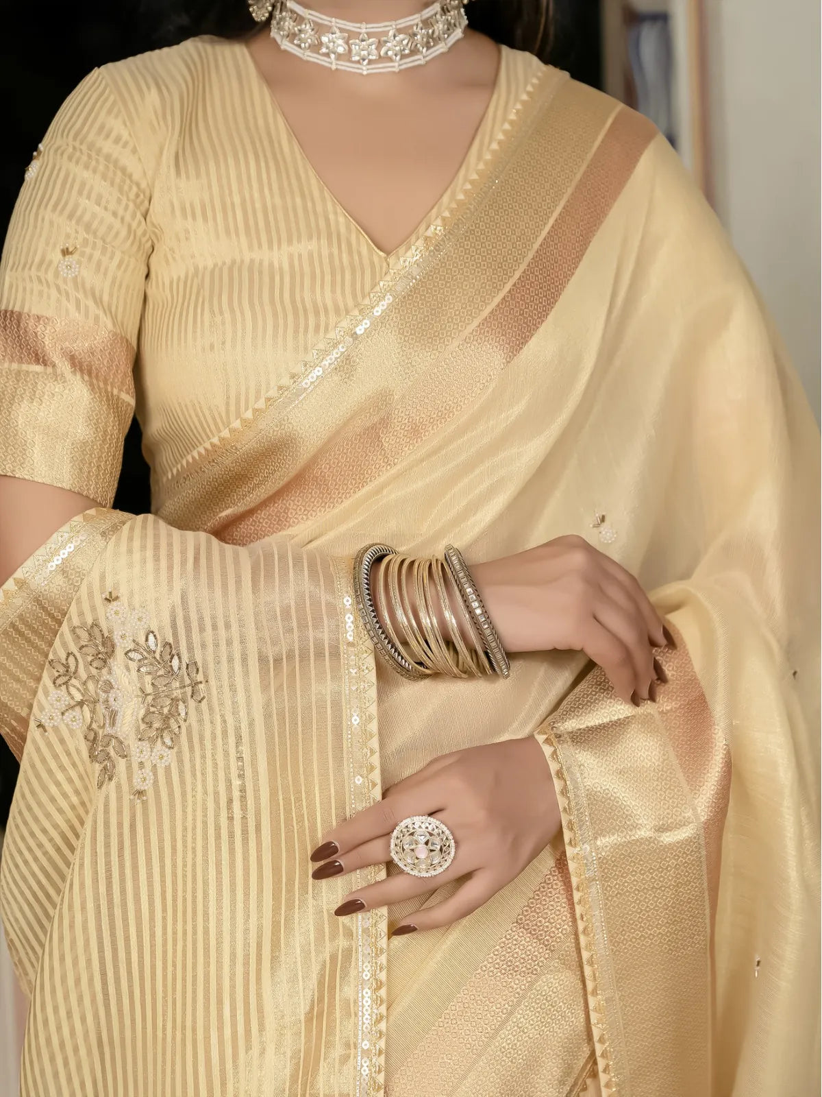 Tarani beige tissue linen saree closeup view highlighting zari border and embroidery