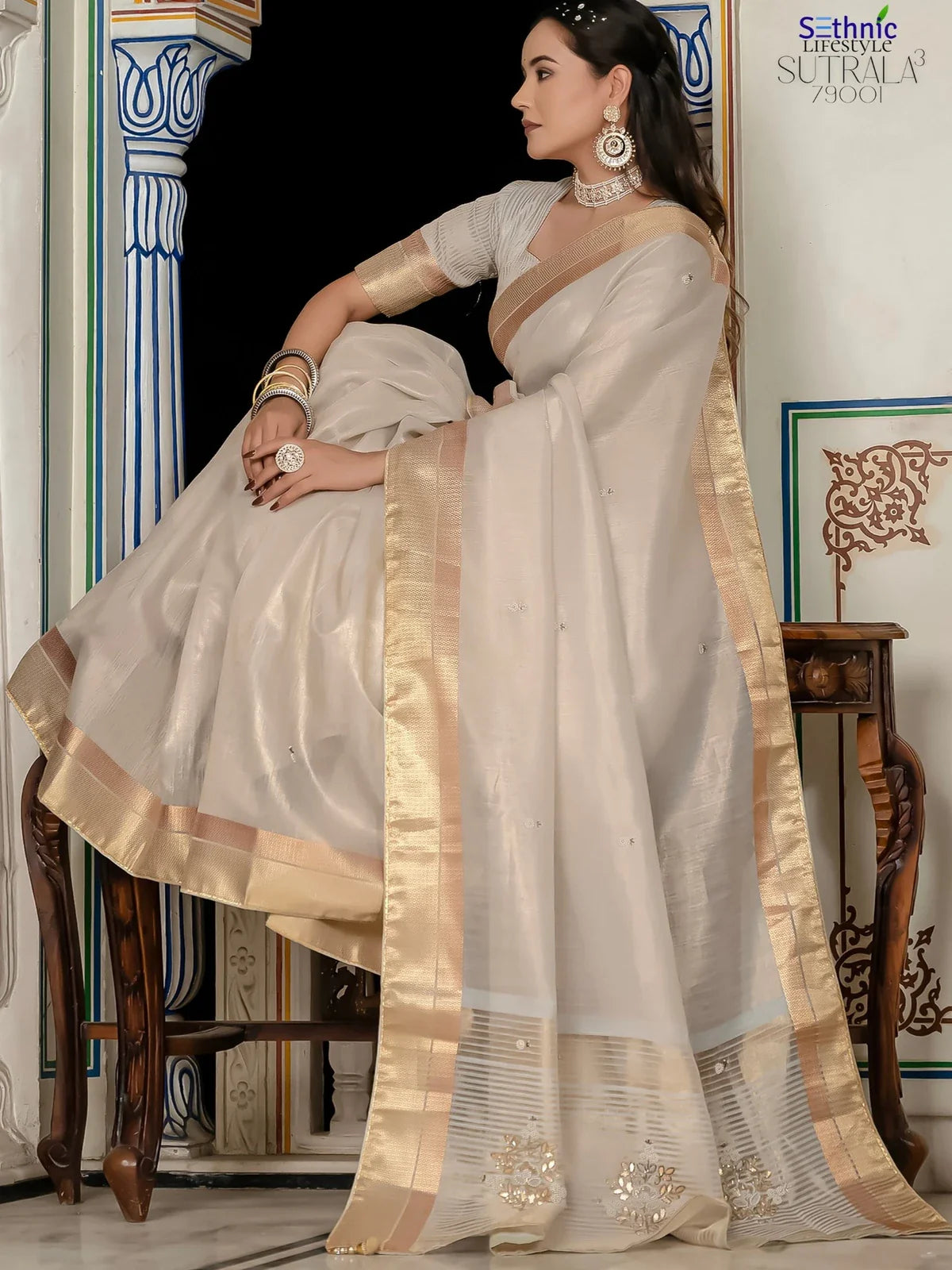 Tarani off white tissue linen saree side view with elegant zari border