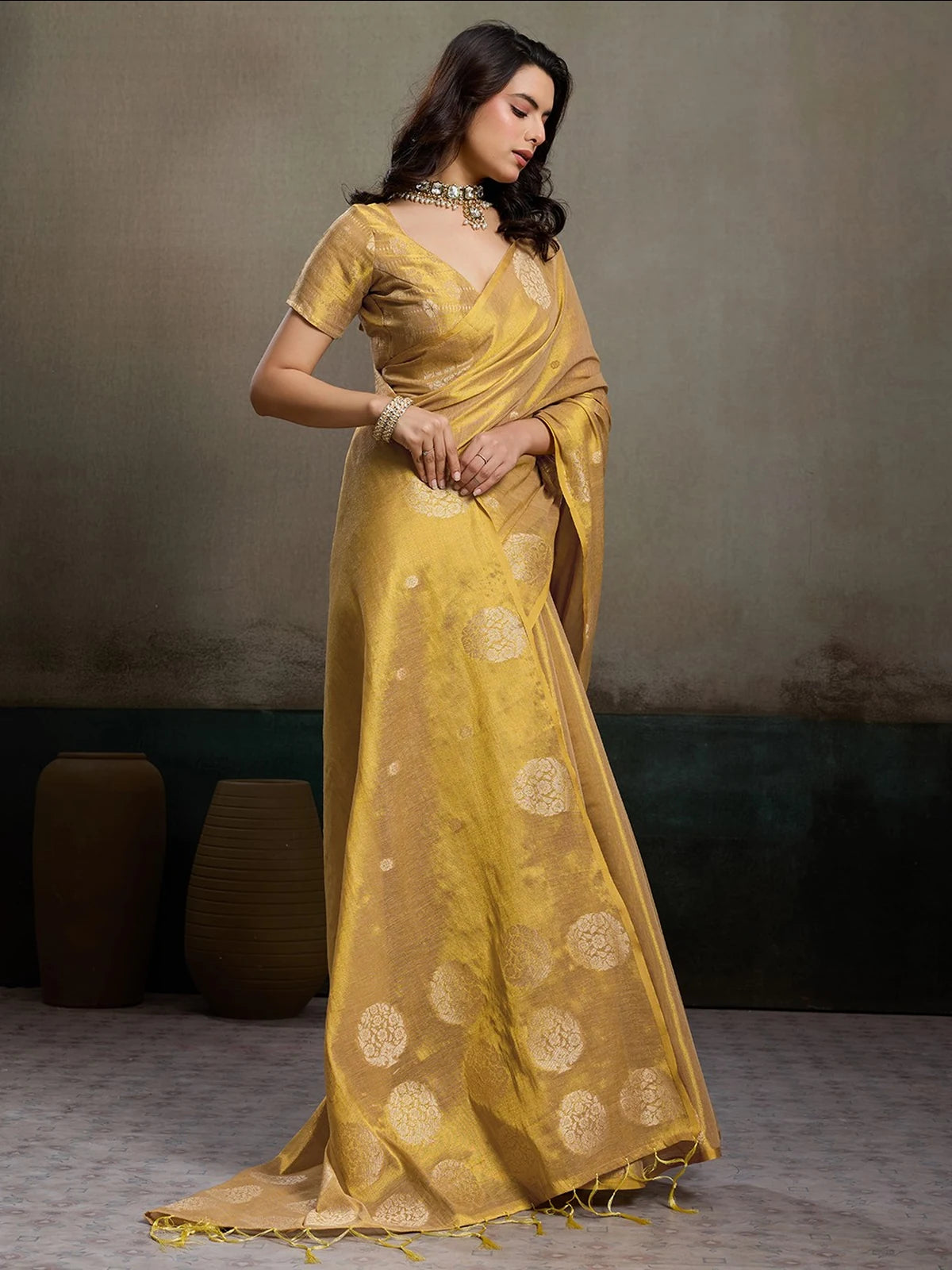Tarani Samaira golden tissue silk saree front view with zari woven circular motifs and tassel border