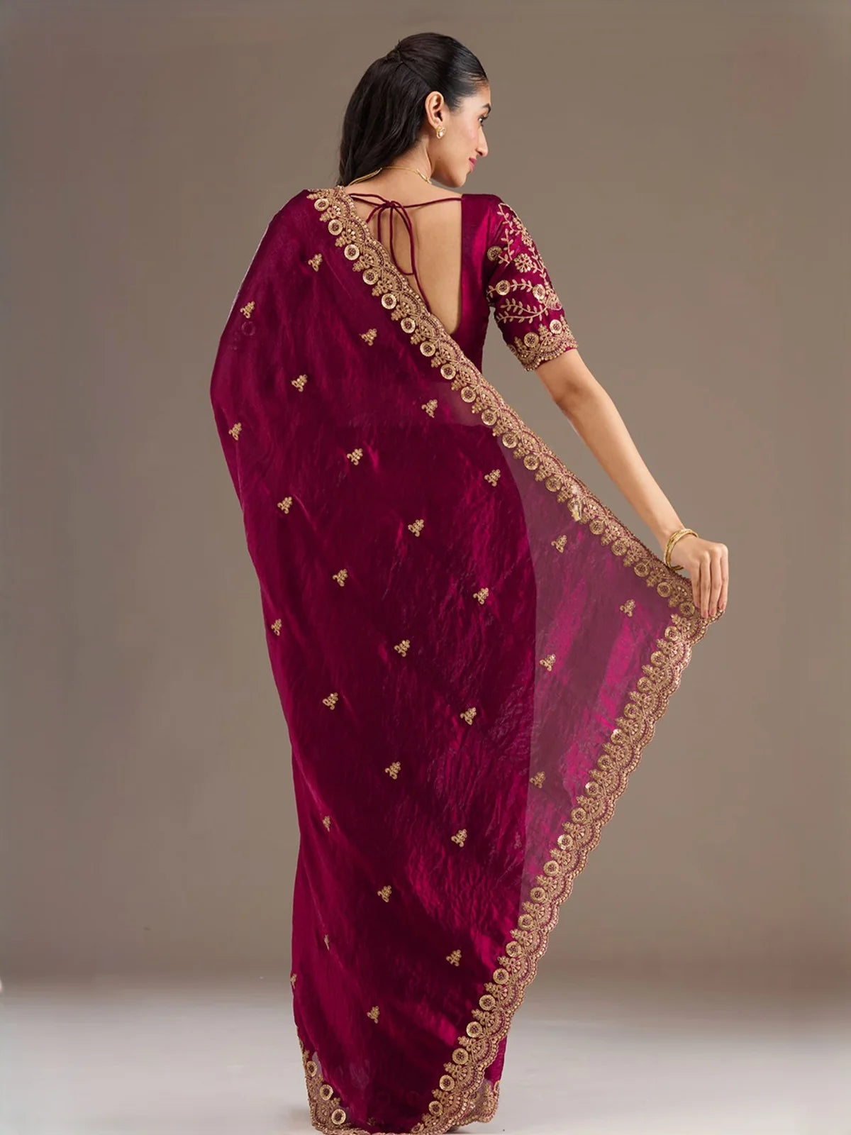 Tarani Akshaya maroon tissue saree back view showing blouse design and embroidered pallu
