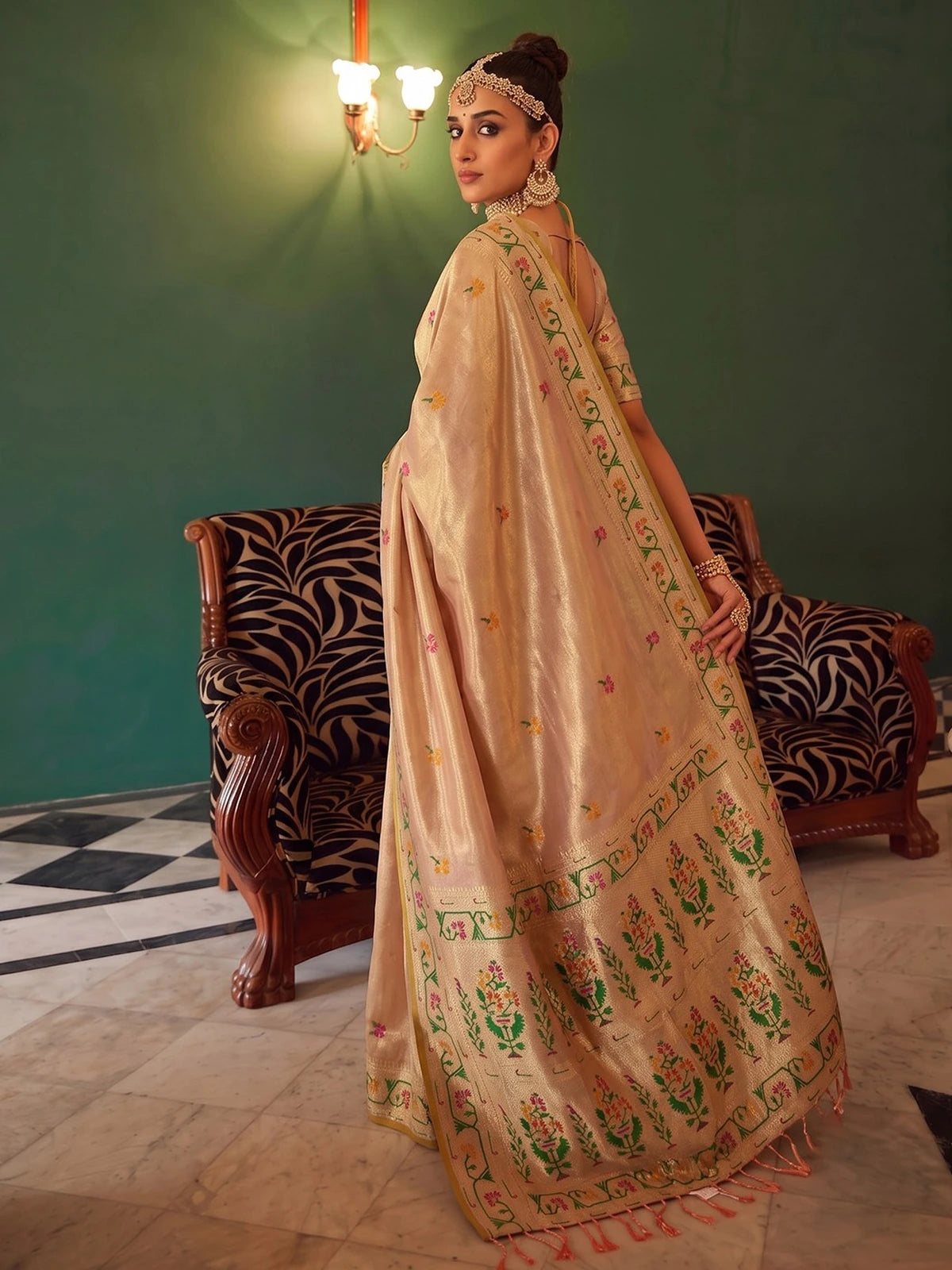 Tarani Kashmira beige tissue silk saree side view showcasing woven border and flowing designer pallu