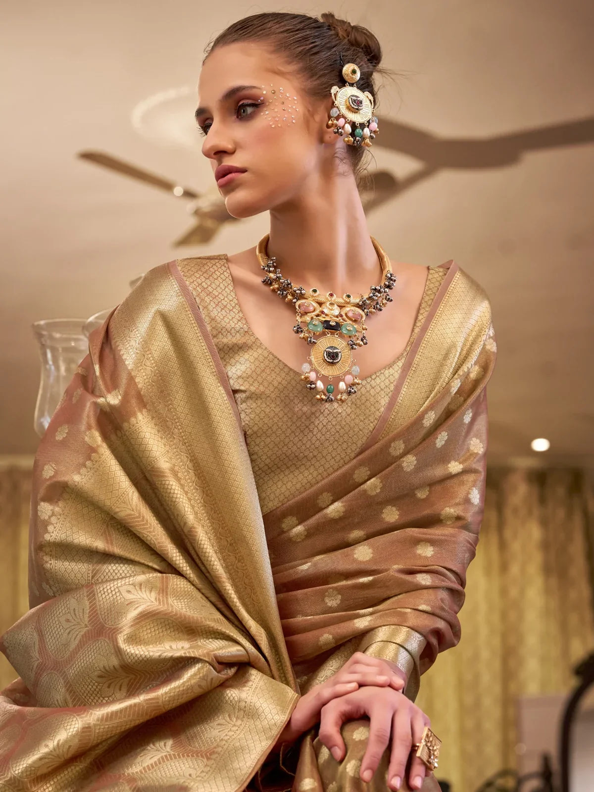 Tarani golden tissue silk saree closeup showing textured weave and small buti motifs