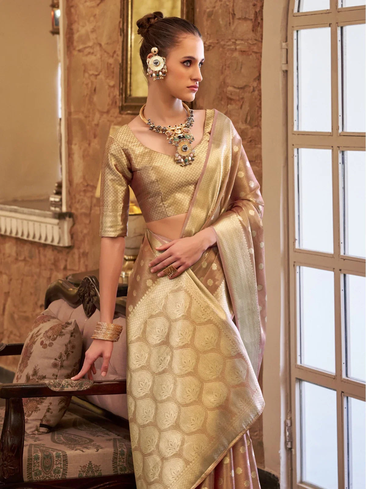 Tarani golden tissue silk saree side view highlighting ornate pallu and border with graceful drape