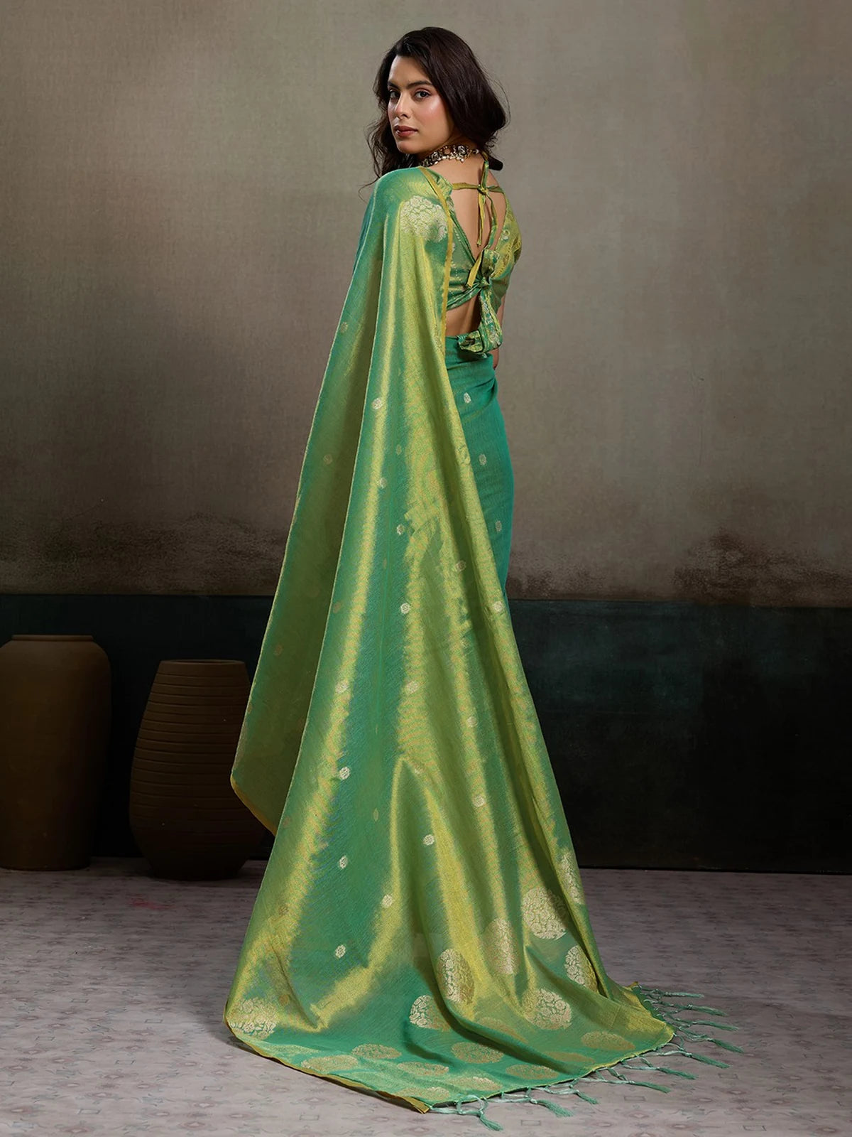 Tarani green tissue silk saree back view showcasing blouse back design and pallu drape