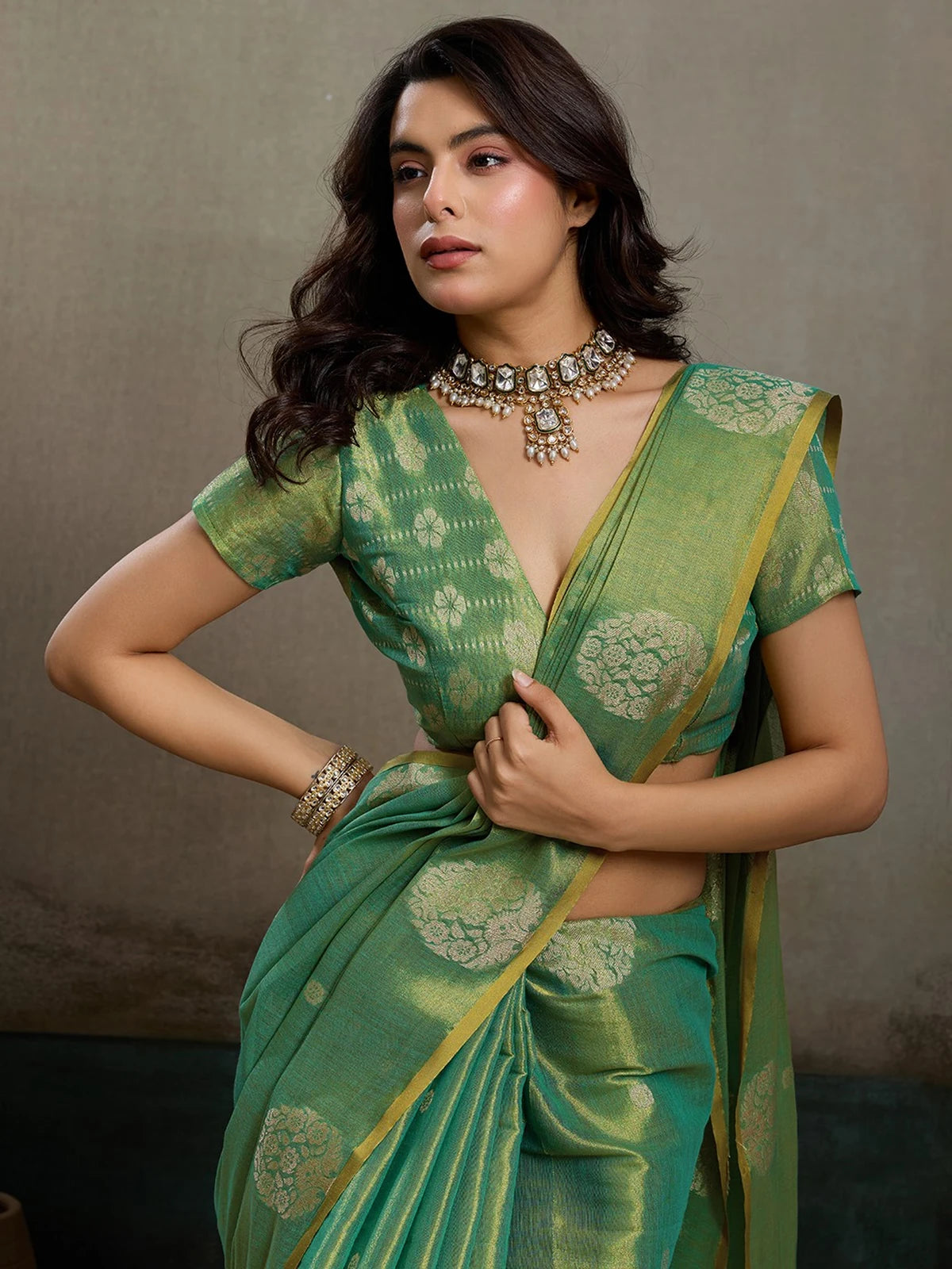 Tarani green tissue silk saree closeup view highlighting blouse and zari woven motifs