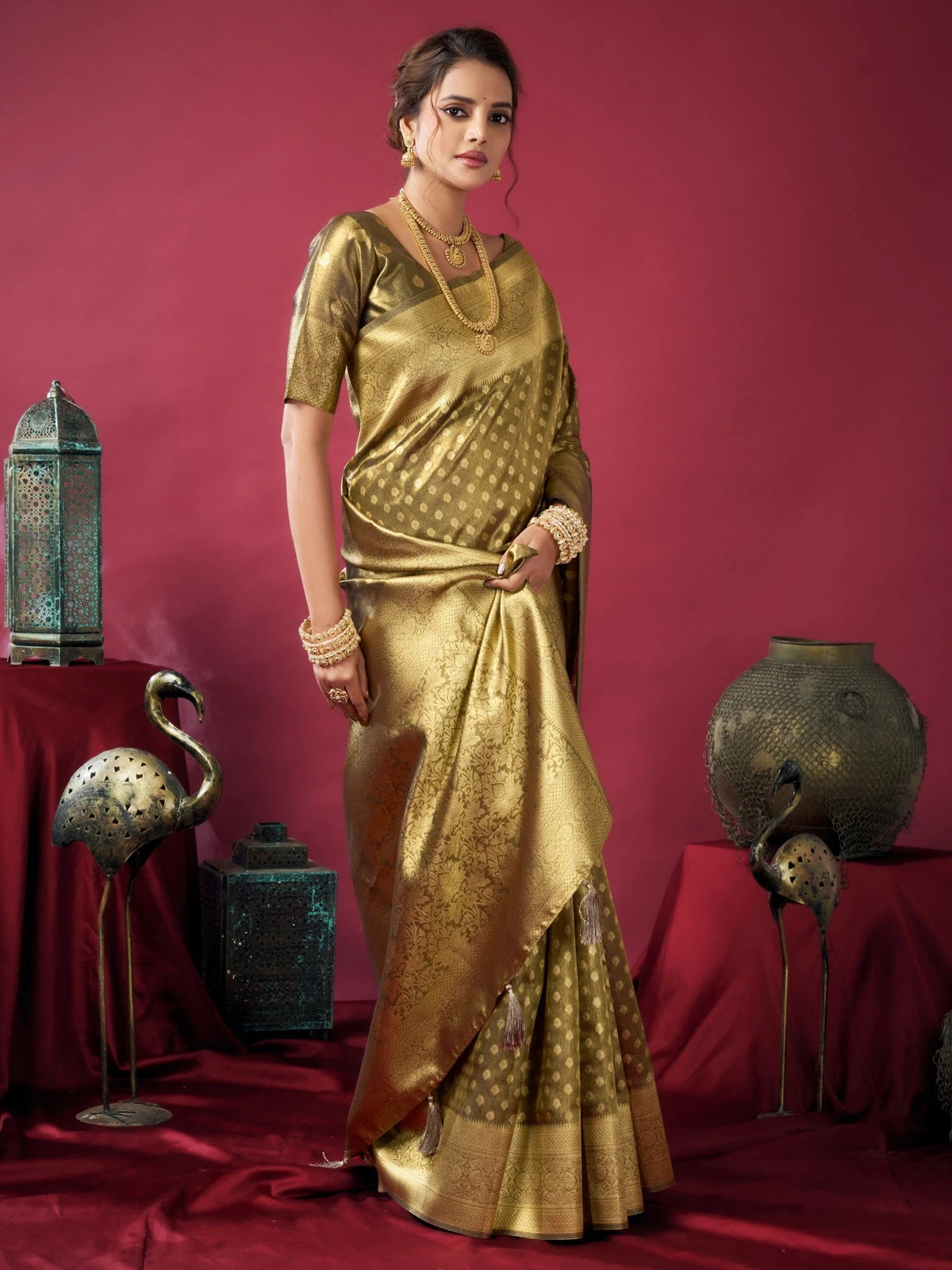Tarani Snehal green Tissue Silk saree side view with graceful pleats and shimmering woven design