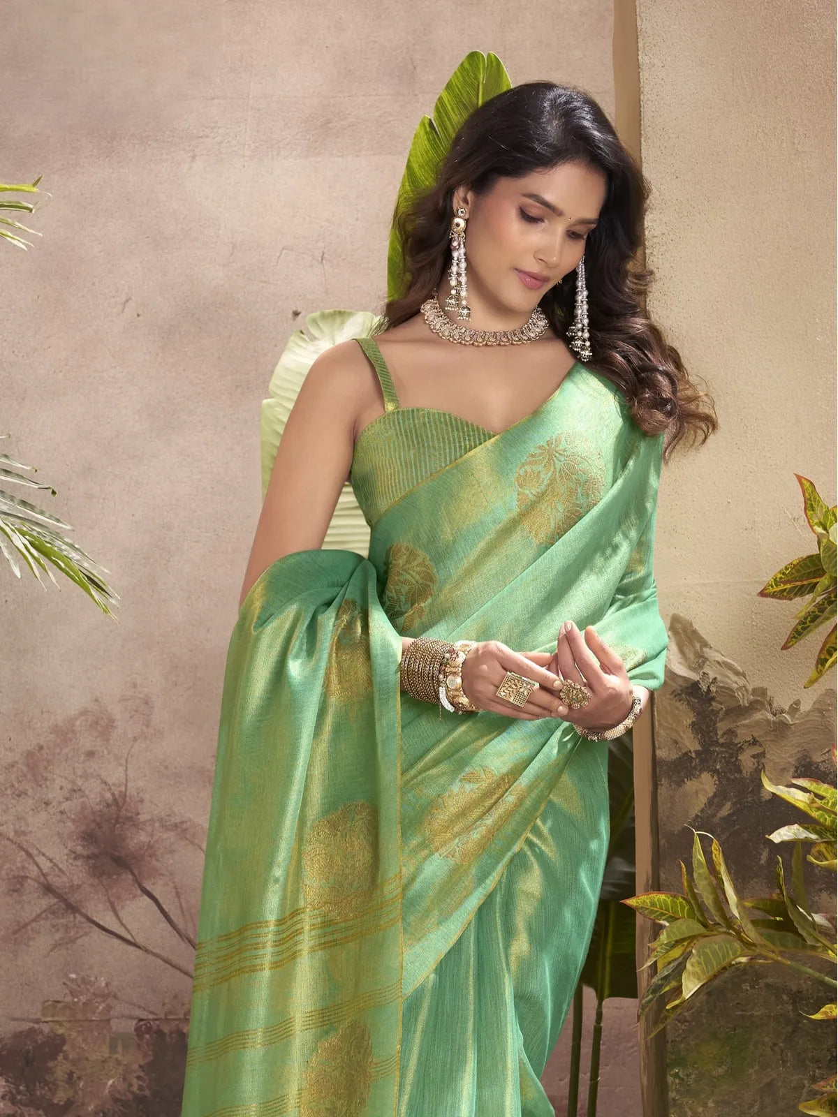Tarani green tissue silk saree side pose highlighting border and woven detailing