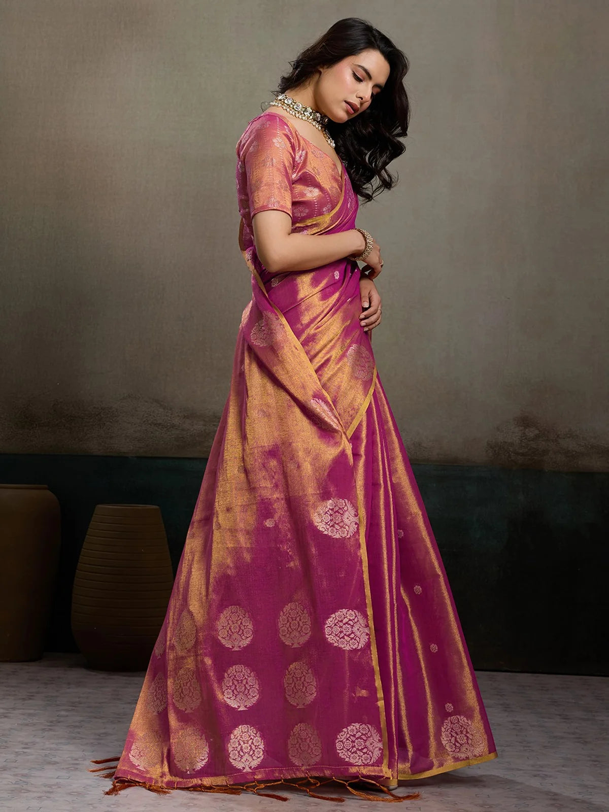 Tarani magenta tissue silk saree side view with shimmering weave and tassel pallu